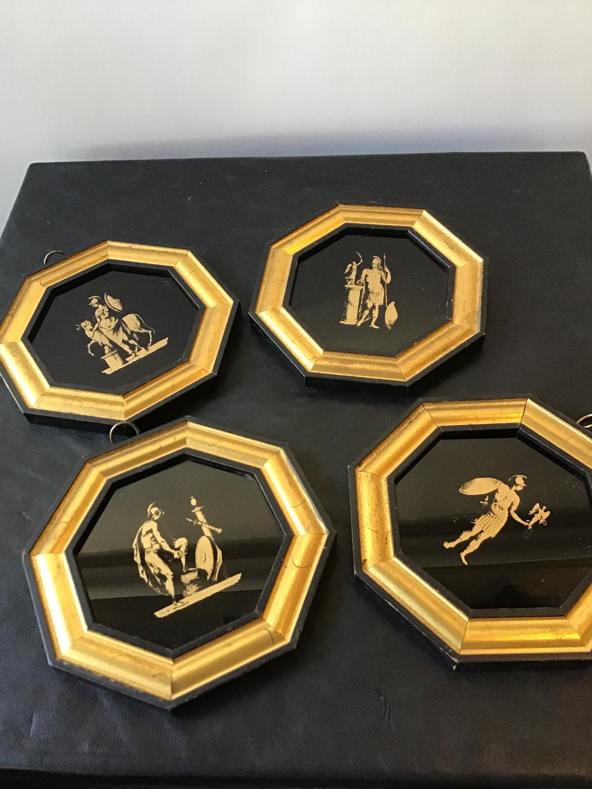 Four 1950s classical gold transfer ware pictures on glass of Roman soldiers. In gold wood frames.