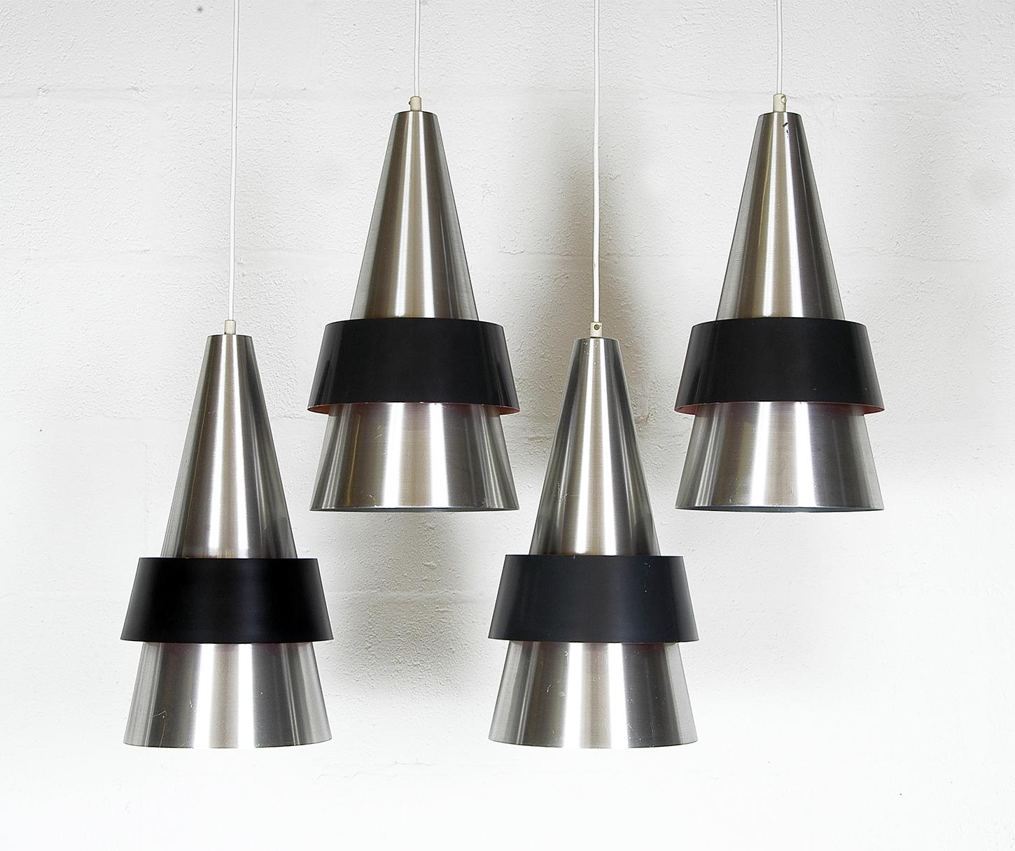 Four 1960s Danish Corona ceiling pendants by Jo Hammerborg for Fog & Morup. Launched by Fog & Morup in 1963 the conical ‘Corona’ pendant was another instant classic designed by Johannes Hammerborg, their head of design. 
Comprising a spun aluminium
