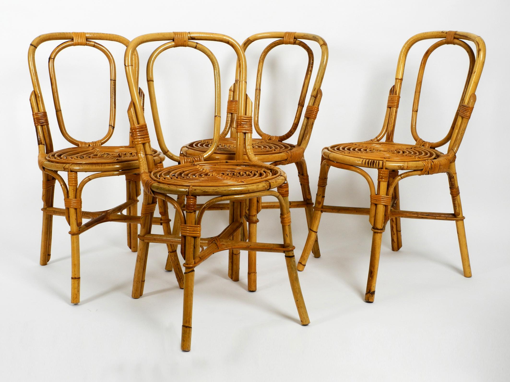 Four rare and extraordinary 1960s bamboo dining chairs in very good vintage condition. 
Made in Italy. Beautiful design and very comfortable to sit on.
Completely made of bamboo very elaborate design.
All four chairs in very same good condition