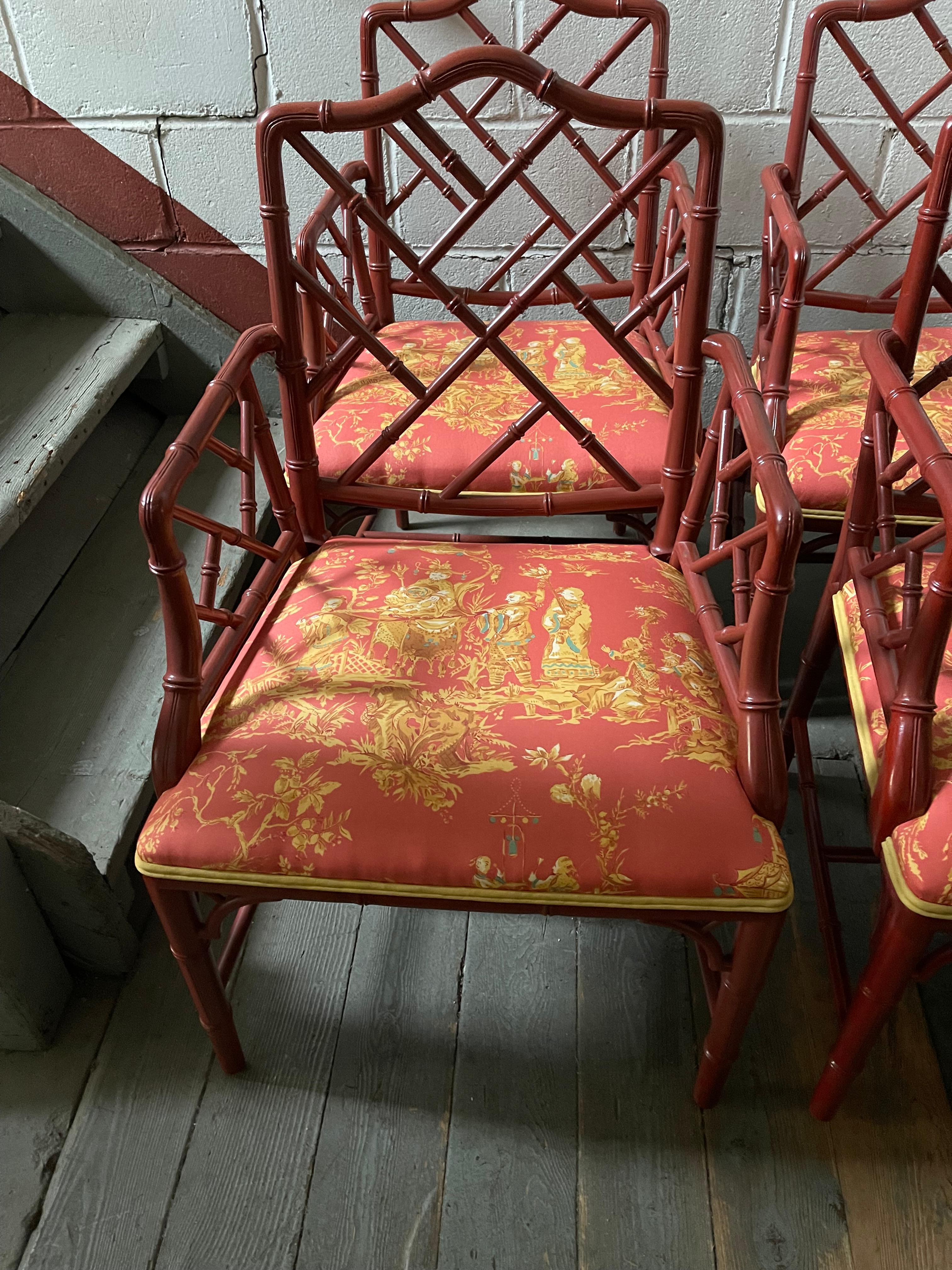 Four 1970s Chinese Chippendale Painted Faux Bamboo Terracotta Armchairs made in the 1970s.  Recently upholstered in a Schumacher salmon, yellow and turquoise chintz fabric with yellow cording around each seat.

Dealer: R316TF