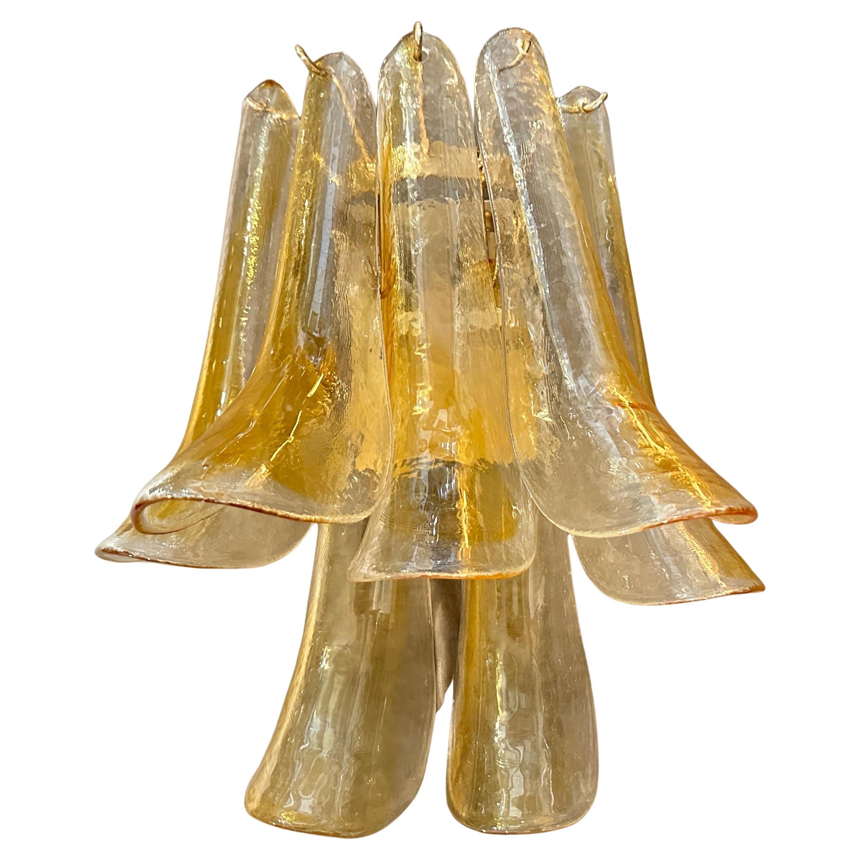 These four wall sconces are exquisite examples of 1970s Mid-Century Modern Italian lighting, crafted by La Murrina, they have mark on each glass. Each sconce features hand-blown Murano glass petals in a stunning combination of clear and amber-brown