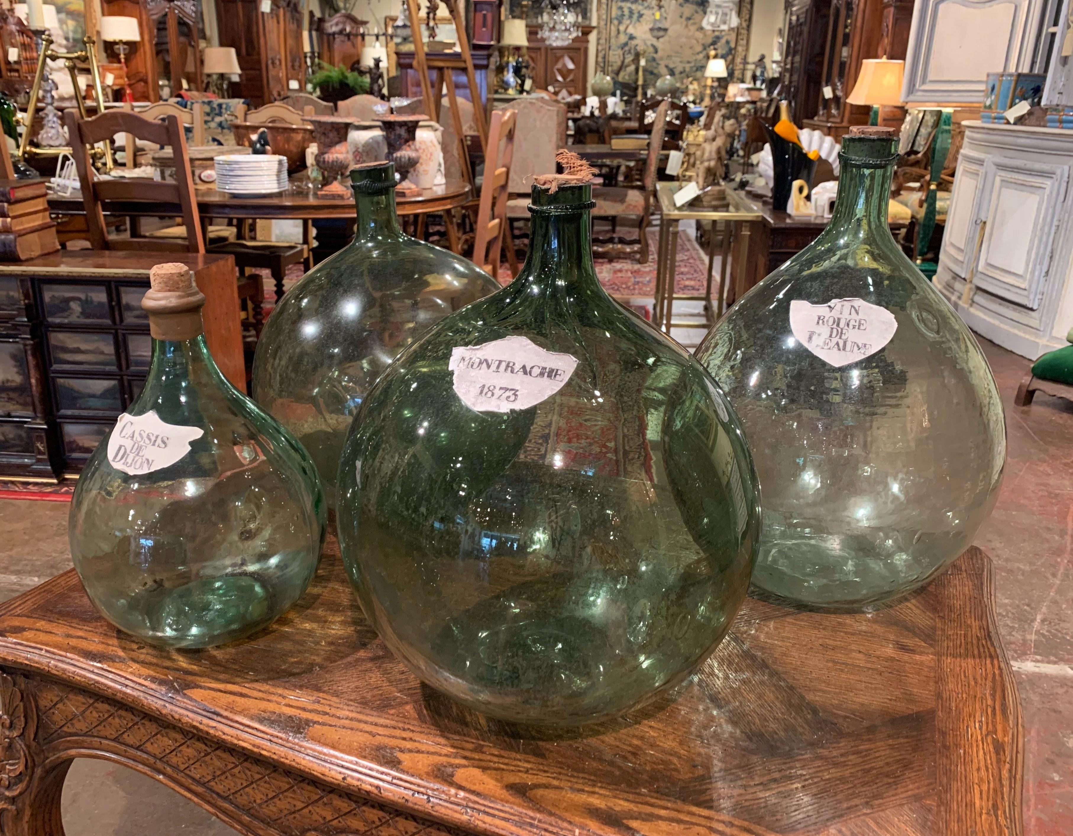 Decorate a wine cellar with these Classic French wine bottles or place them over kitchen cabinets! Hand blown in France circa 1880, the glass bottles are beautifully decorated with a painted paper label, including 