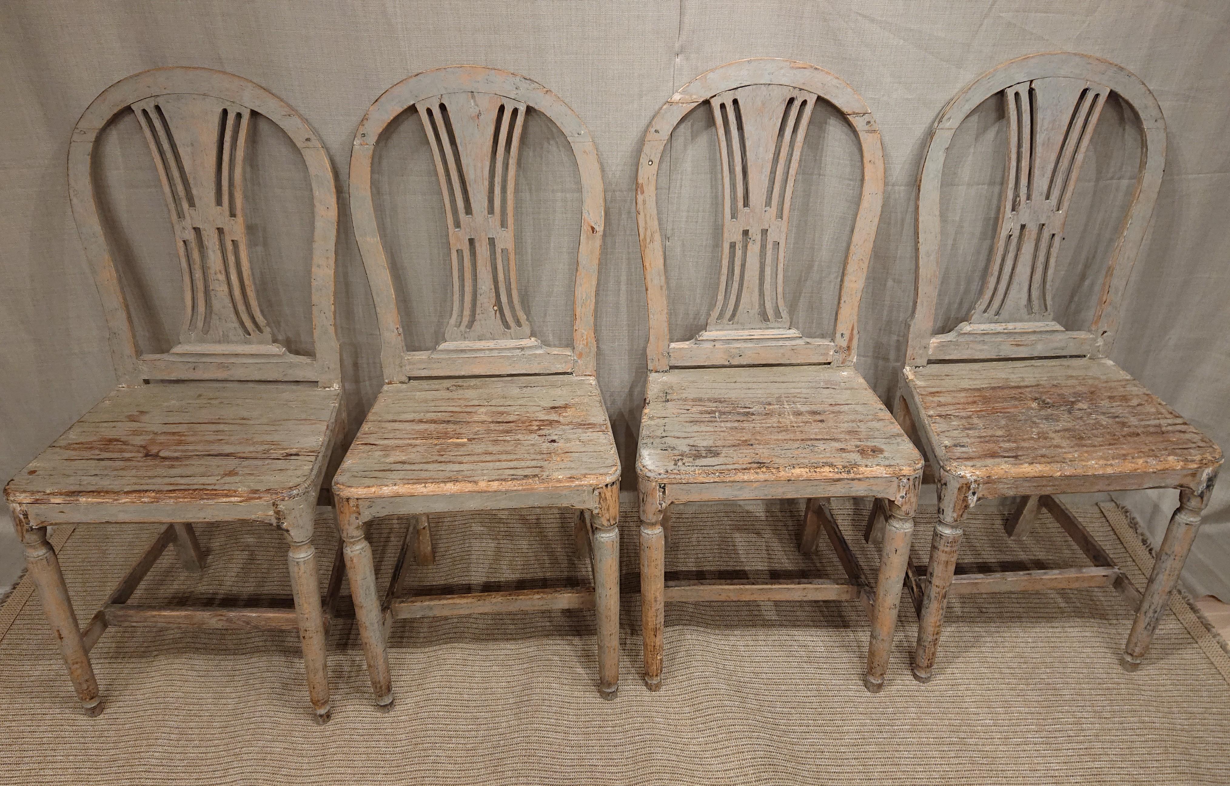 19th century Swedish Gustavian chairs 
A set of four gustavian chairs with slats in the back and wooden seat.
These beautiful chairs have been hand-scraped to the original paint which has a stunning patina.
Age related wear consistent with past