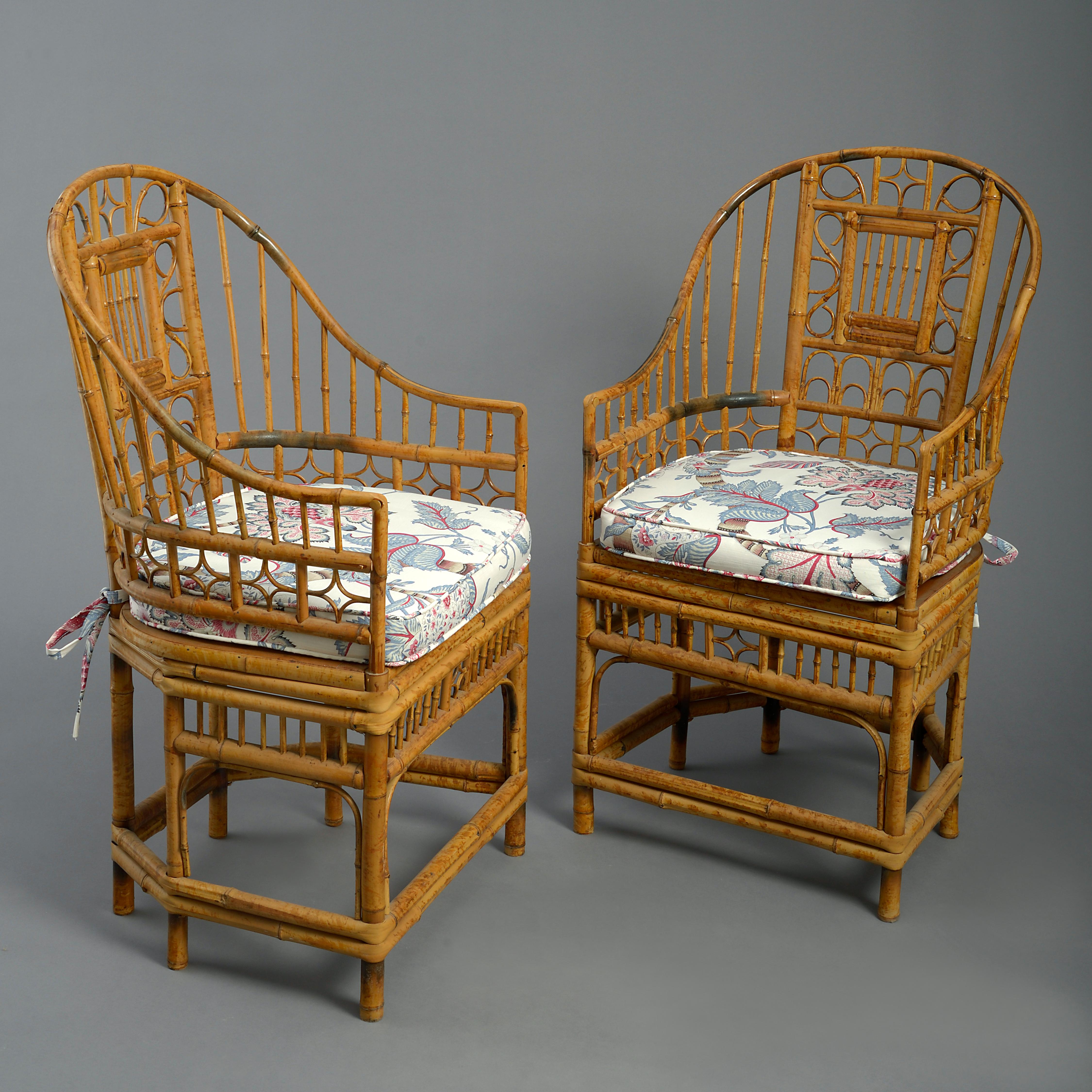 A set of four mid-twentieth century bamboo armchairs, the horseshoe backs with intricate scrollwork decoration, raised upon legs with conjoining stretchers. Together with squab cushion seats.

These chairs show stylistic influence of the suites of