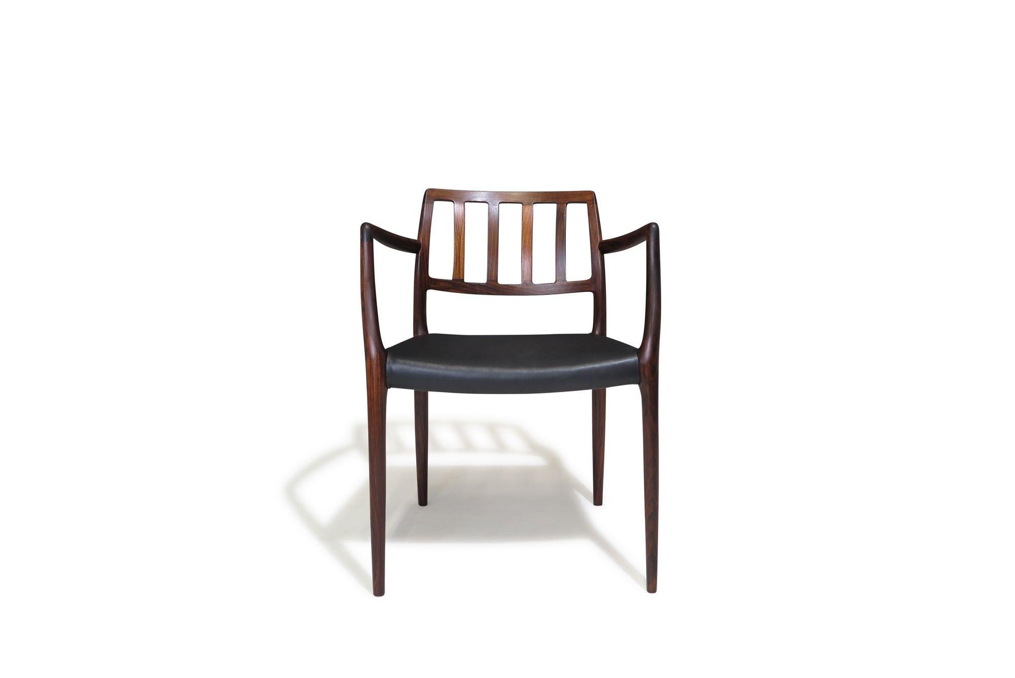 Poltrone danesi di metà secolo in palissandro disegnate da Niels Moller per J.L. Moller, Modello 66, Danimarca, circa 1974. La struttura della sedia è realizzata in legno massiccio di palissandro santos, con braccioli scultorei e rivestimento in