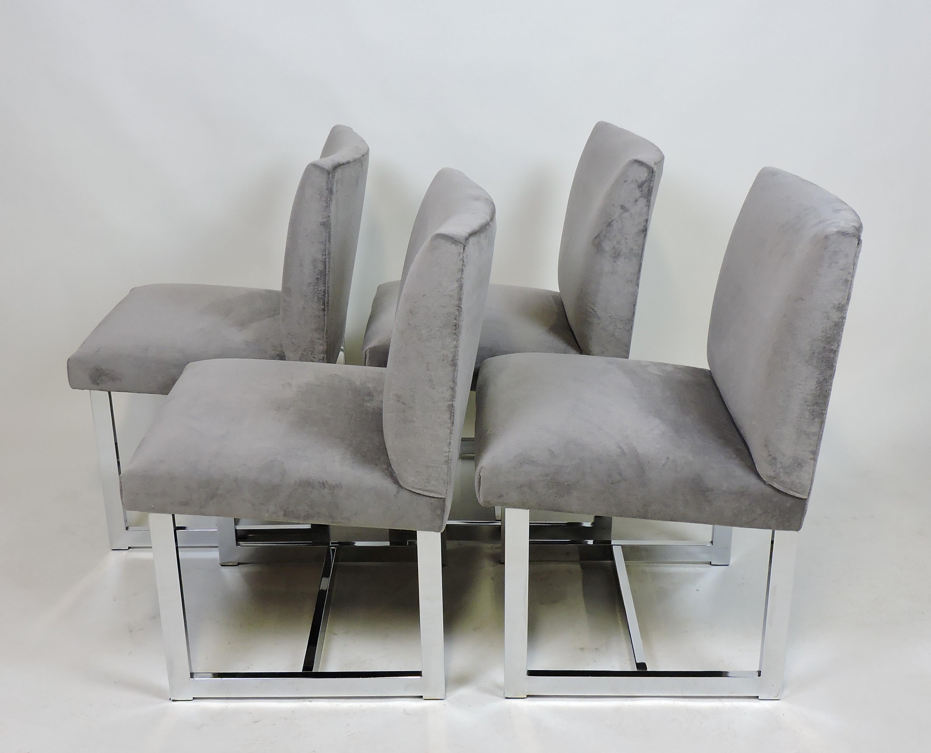 Handsome set of four dining chairs designed by Adrian Pearsall for Comfort Designs. These chairs have been newly upholstered in a luxurious gray velvet and rest on chrome bases. Labeled with the original label.
  