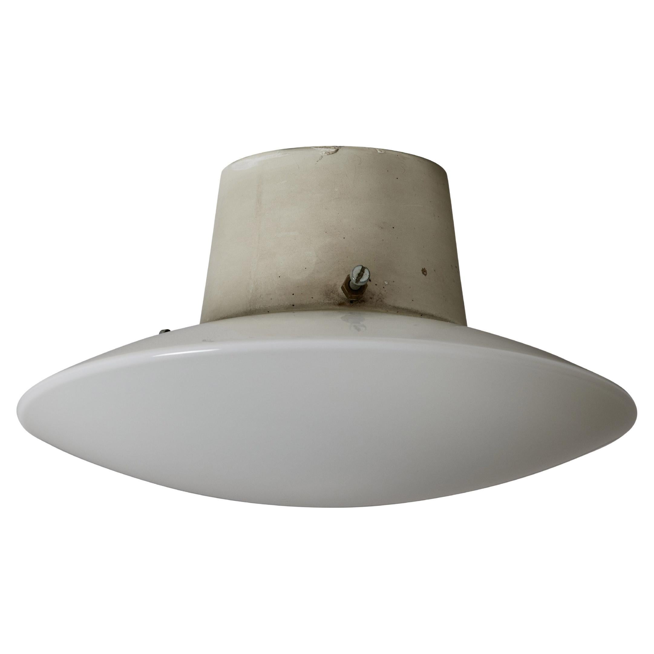 AJ Eklipta flush mount by Arne Jacobsen for Louis Poulsen. Designed and manufactured in the Netherlands, circa 1960's. Enameled metal, opaline glass diffuser. Wired for U.S. standards. This light holds a single E14 socket type, adapted for the US.