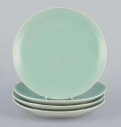 Four Aluminia "Confetti" plates in mint green glazed earthenware. Mid-20th C