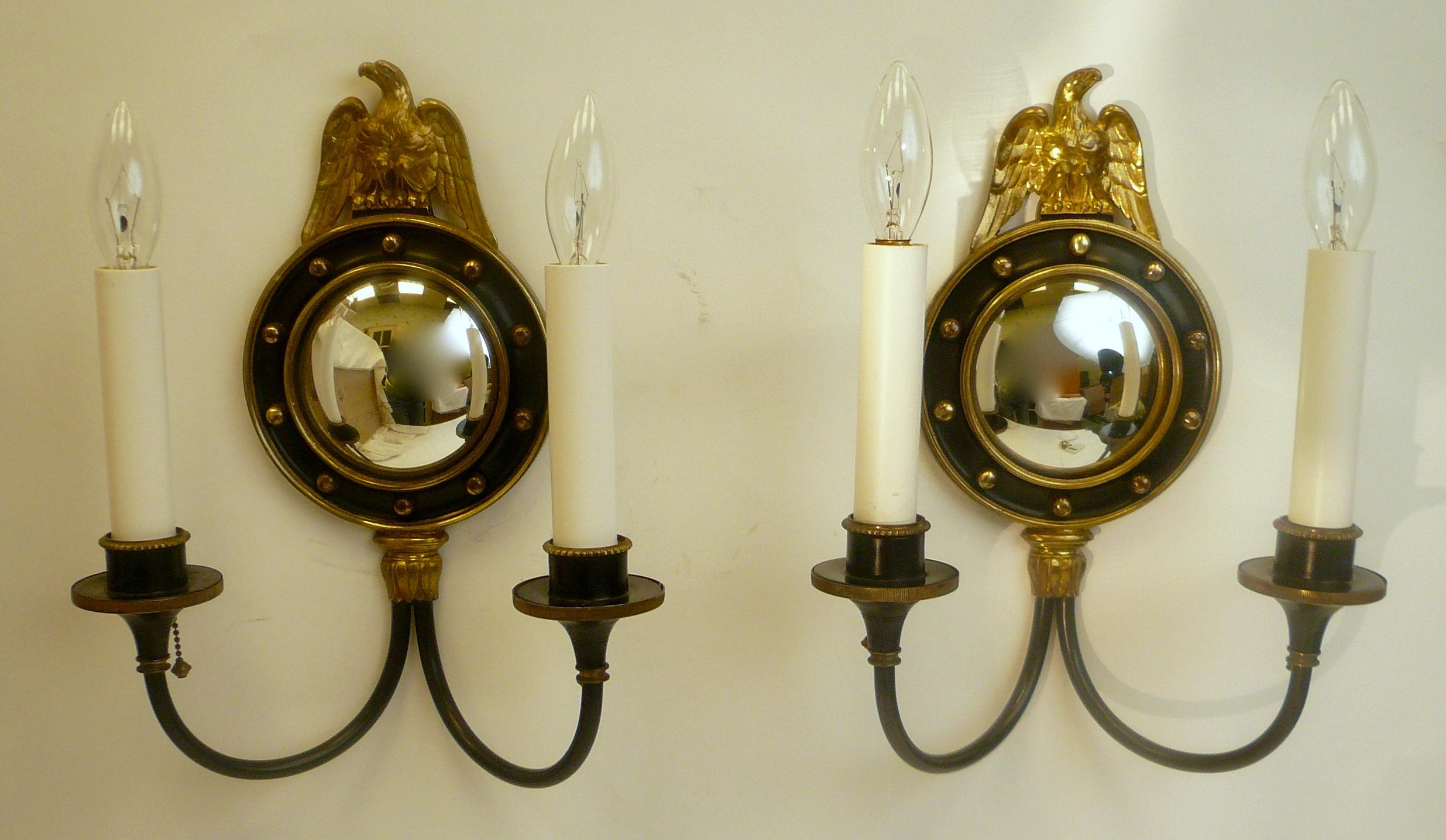 These quality sconces feature mirror image cast bronze eagles, and convex mirrors. They were purchased from the estate of Mrs. H J Heinz II.