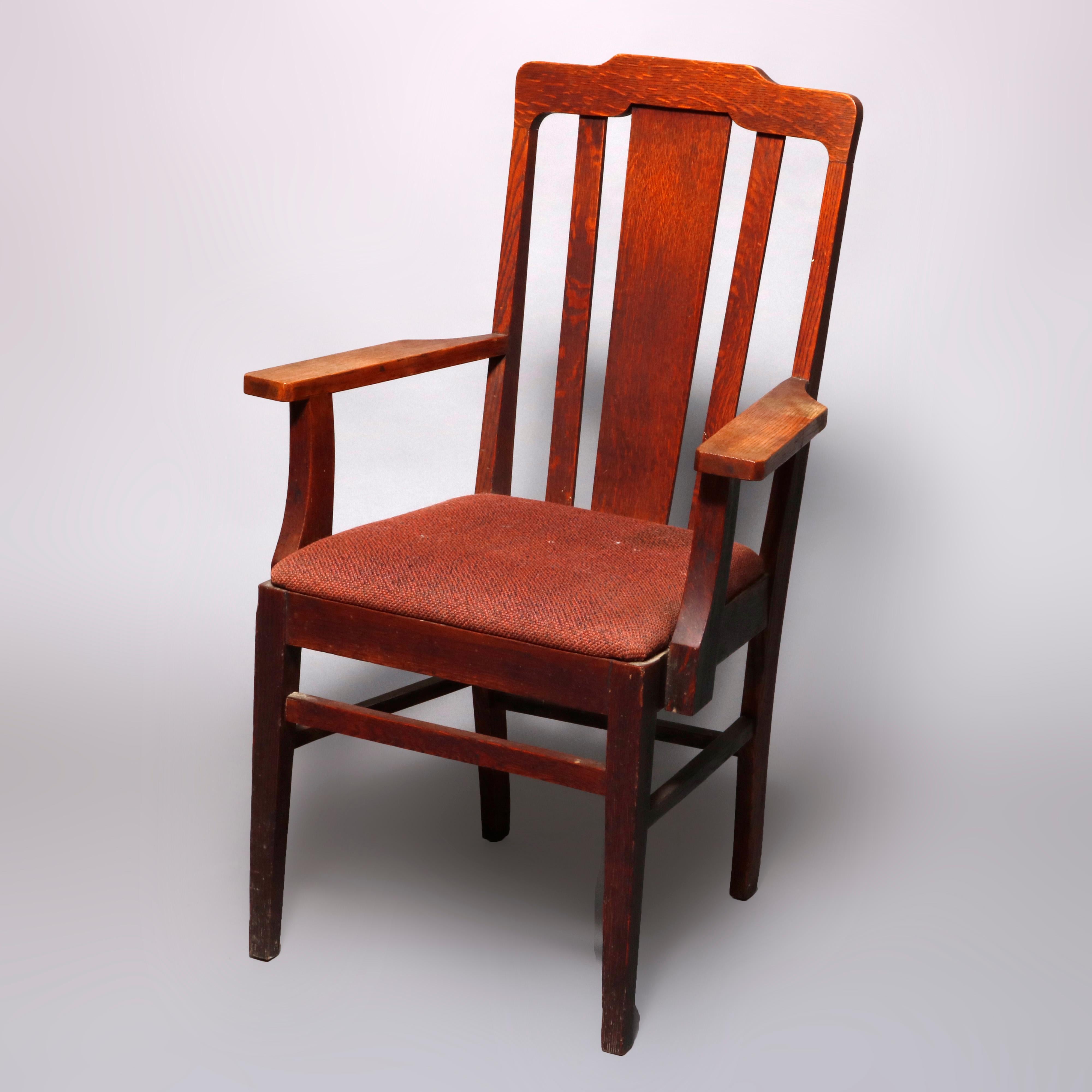 An antique set of 4 Arts & Crafts mission oak dining chairs in the manner of Gustav Stickley offer shaped rail surmounting slat backs and raised on square and straight legs, includes one armchair and three side chairs, circa 1910

Measures: Master