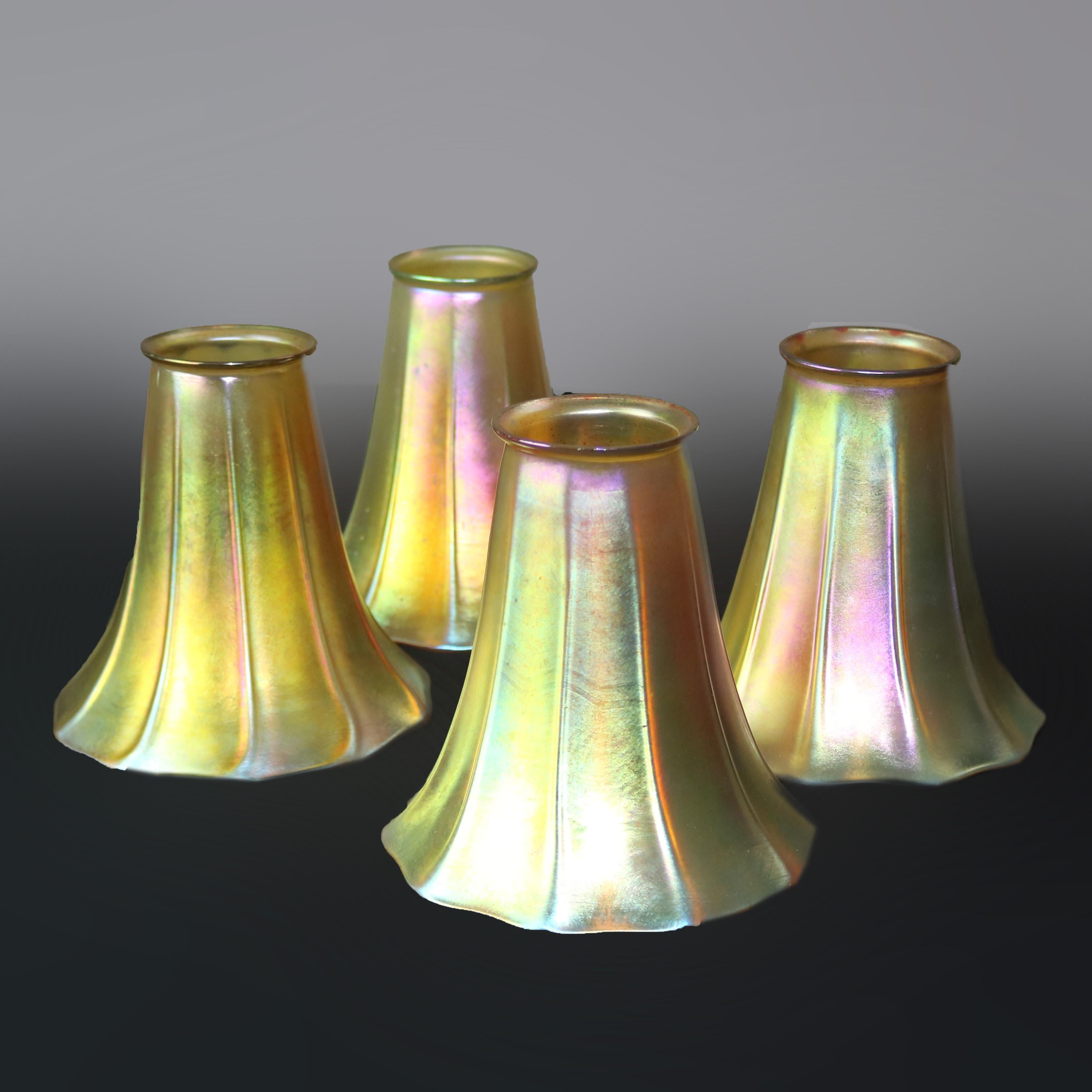 A set of four antique Arts & Crafts lamp shades by Steuben offer gold Aurene art glass in faceted and flared tulip form, unsigned, circa 1920.

Measures: 5
