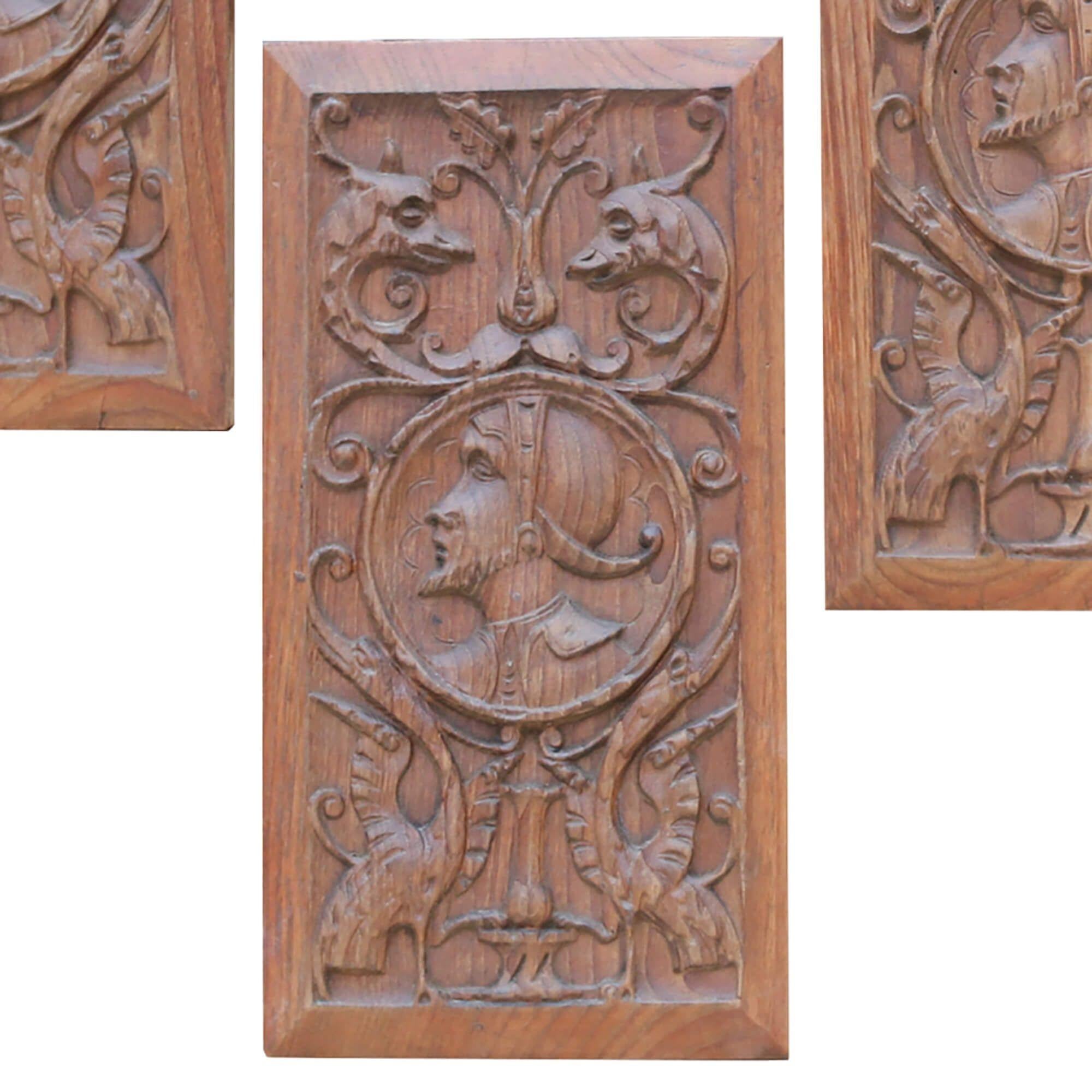 Four handsomely carved antique oak panels depicting mythical creatures and gentlemen in period costume. Dating from the early 20th century, these beautiful panels are handcrafted, making a beautiful feature on an interior wall in a period property.