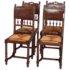 Four Antique French Renaissance Carved Walnut and Leather Dining Chairs