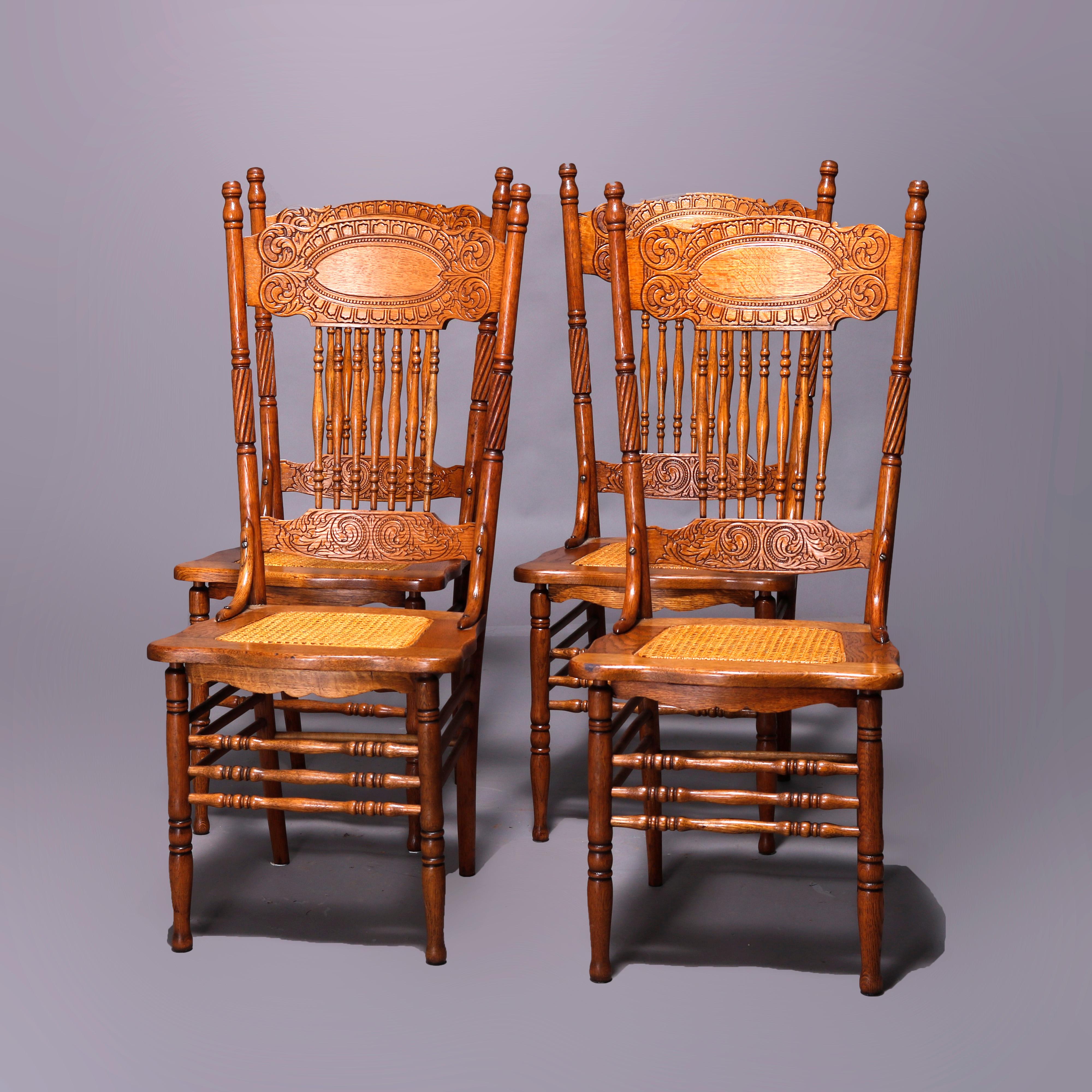 A set of four antique Larkin #1 dining chairs offer quarter sawn oak construction with double pressed back having foliate design over spindle support and cane seats, circa 1910

Measures - 43.25'' H x 19.25'' W x 22'' D.