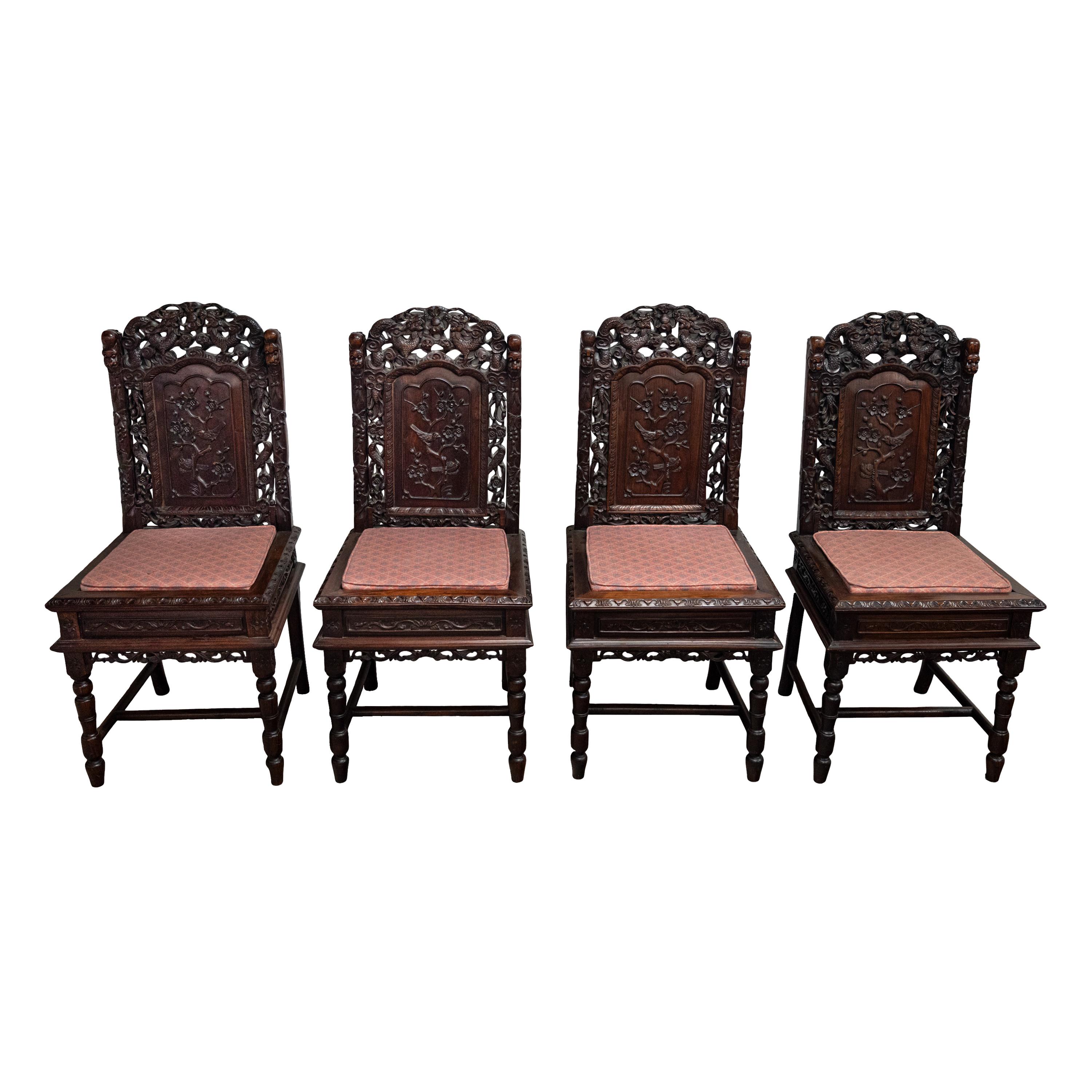 A fine set of four antique Chinese Qing dynasty carved rosewood dragon chairs, circa 1880.
Each chair is finely carved crest with two facing dragons and a flaming pearl, signifying prosperity and wisdom, to each side of the crest is a carved foo dog