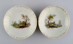 Four antique Royal Copenhagen porcelain bowls with hand-painted landscapes.