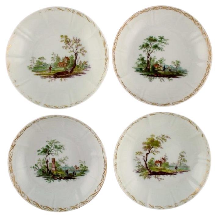 Four antique Royal Copenhagen porcelain bowls with hand-painted landscapes.