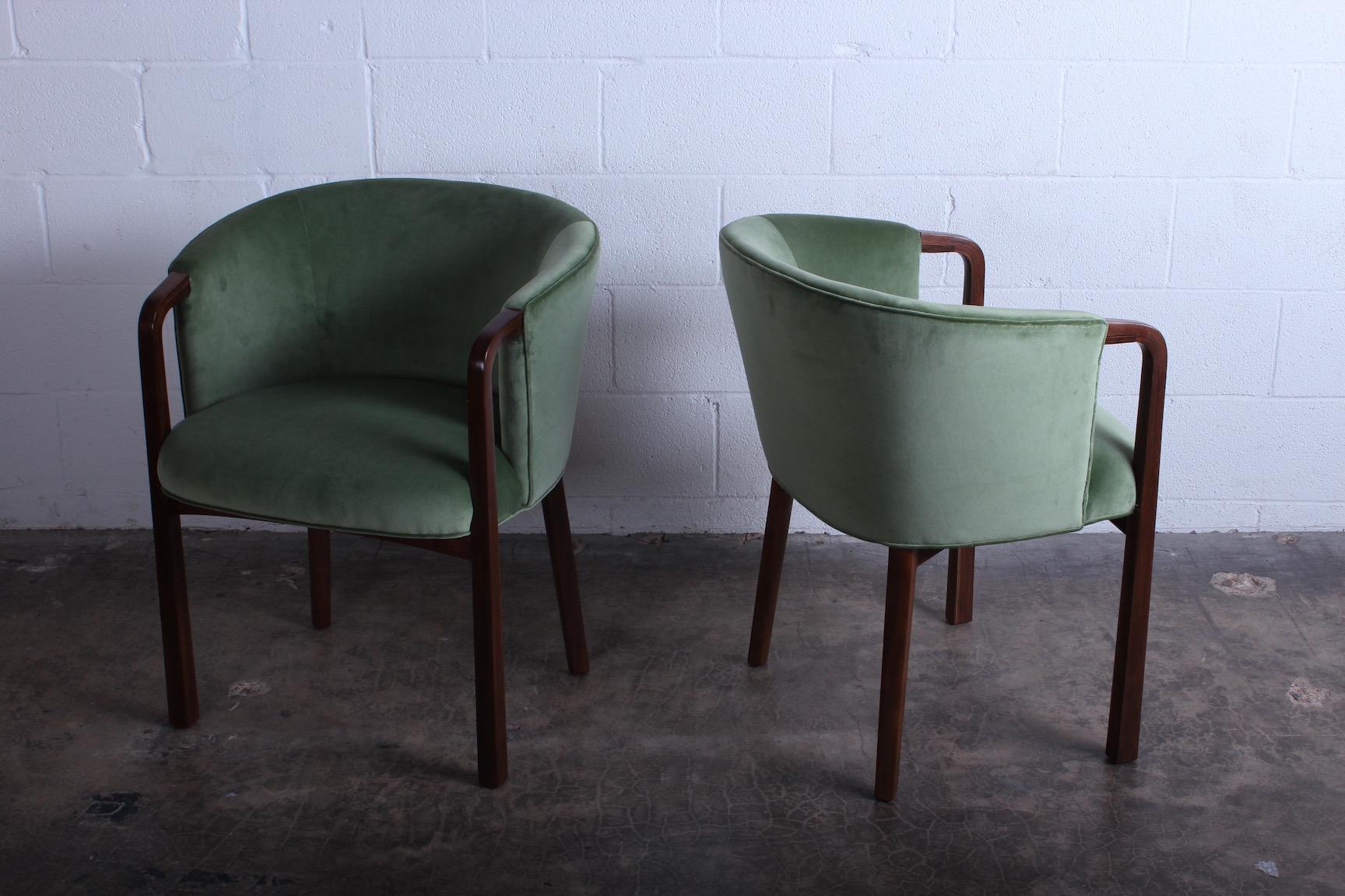 A set of four armchairs/dining chairs by Edward Wormley for Dunbar. Restored walnut frames with new velvet upholstery.