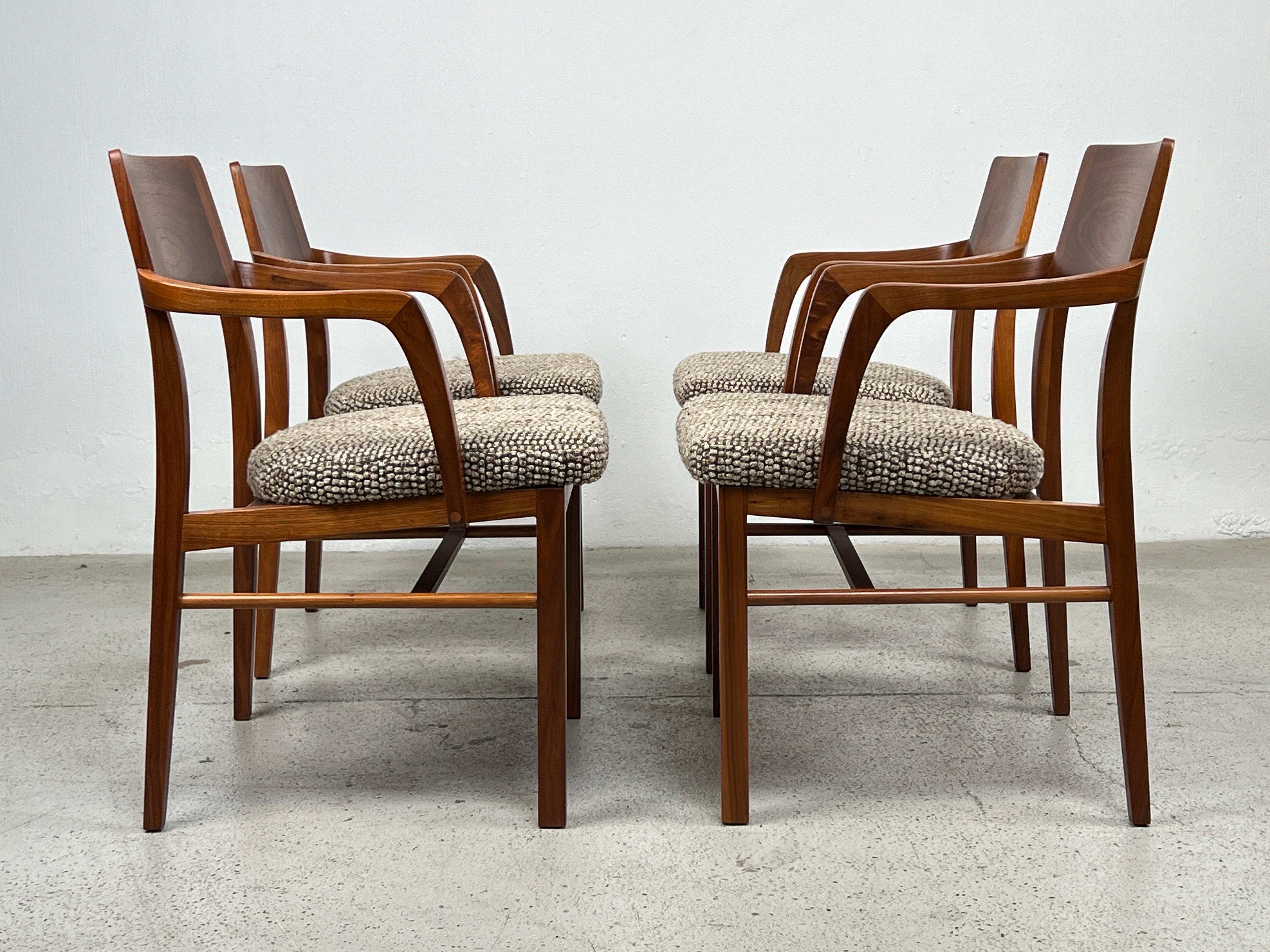 A set of four walnut armchairs designed by Edward Wormley for Dunbar. 