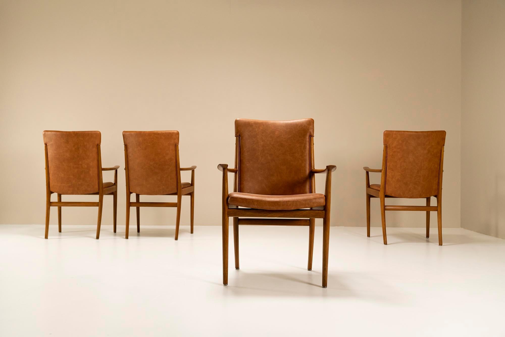 Four beautifully crafted armchairs from Danish designer Kai Lyngfeldt Larsen made and manufactured by Søren Willadsen's factory in the 1960s. Danish ash has been used for this design, which manifests itself in a refined manner. The drawings or