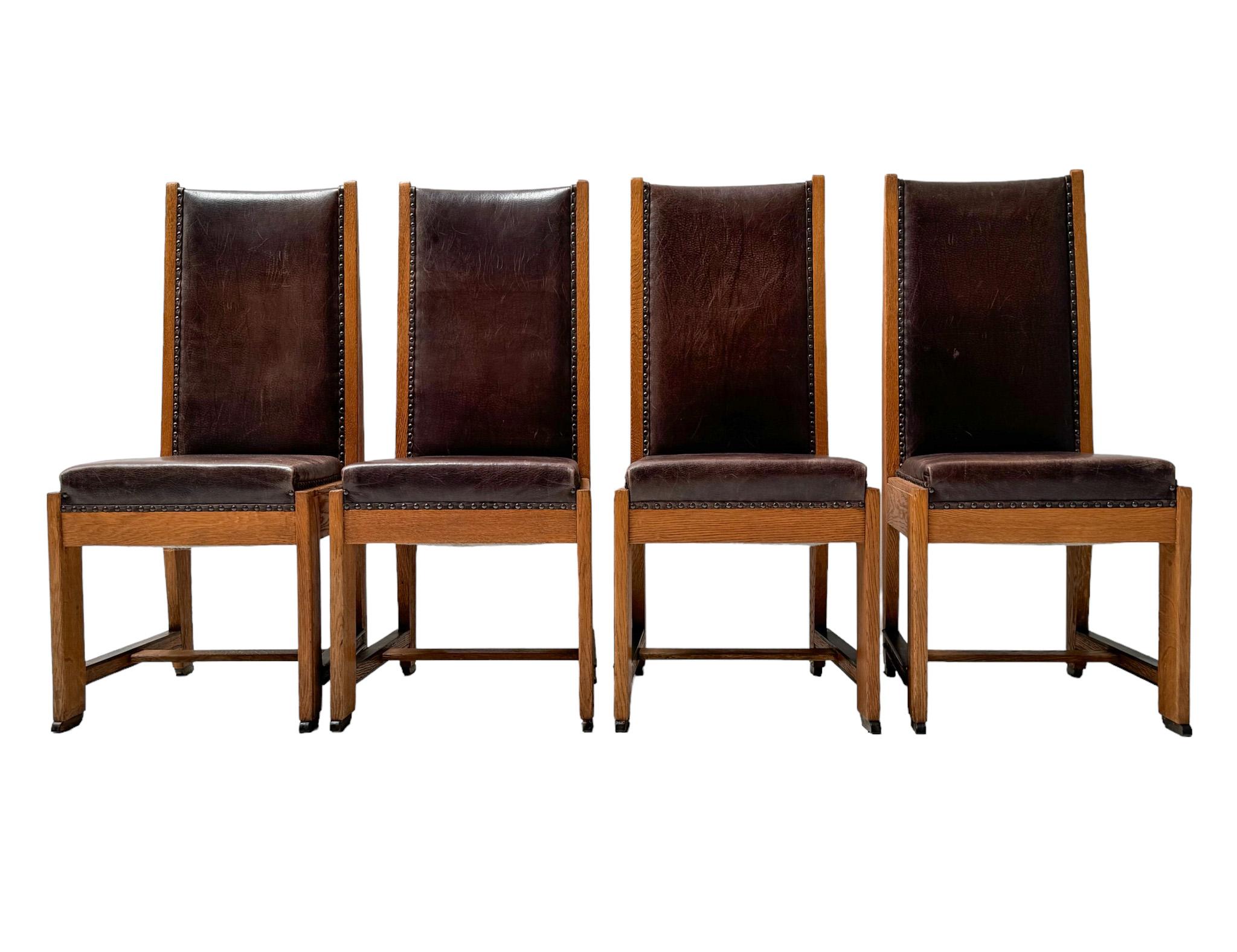 Stunning and elegant set of four Art Deco Modernist high back dining room chairs.
Striking Dutch design from the 1920s.
Solid oak frame with solid macassar ebony elements.
Re-upholstered with a fine quality leather upholstery.
This wonderful set of