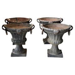 Four Art Deco Urn Form Iron Planters