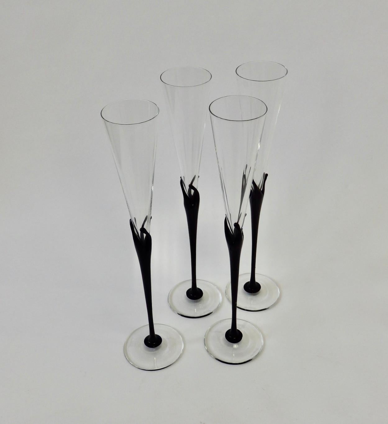 Four tall flutes marked Rosenthal Studio line Germany with designers signature. I cannot make out the name.