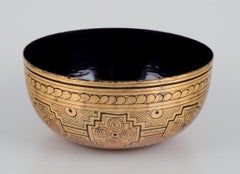 Four Asian bowls made of papier-mâché. Decorated in gold and black.