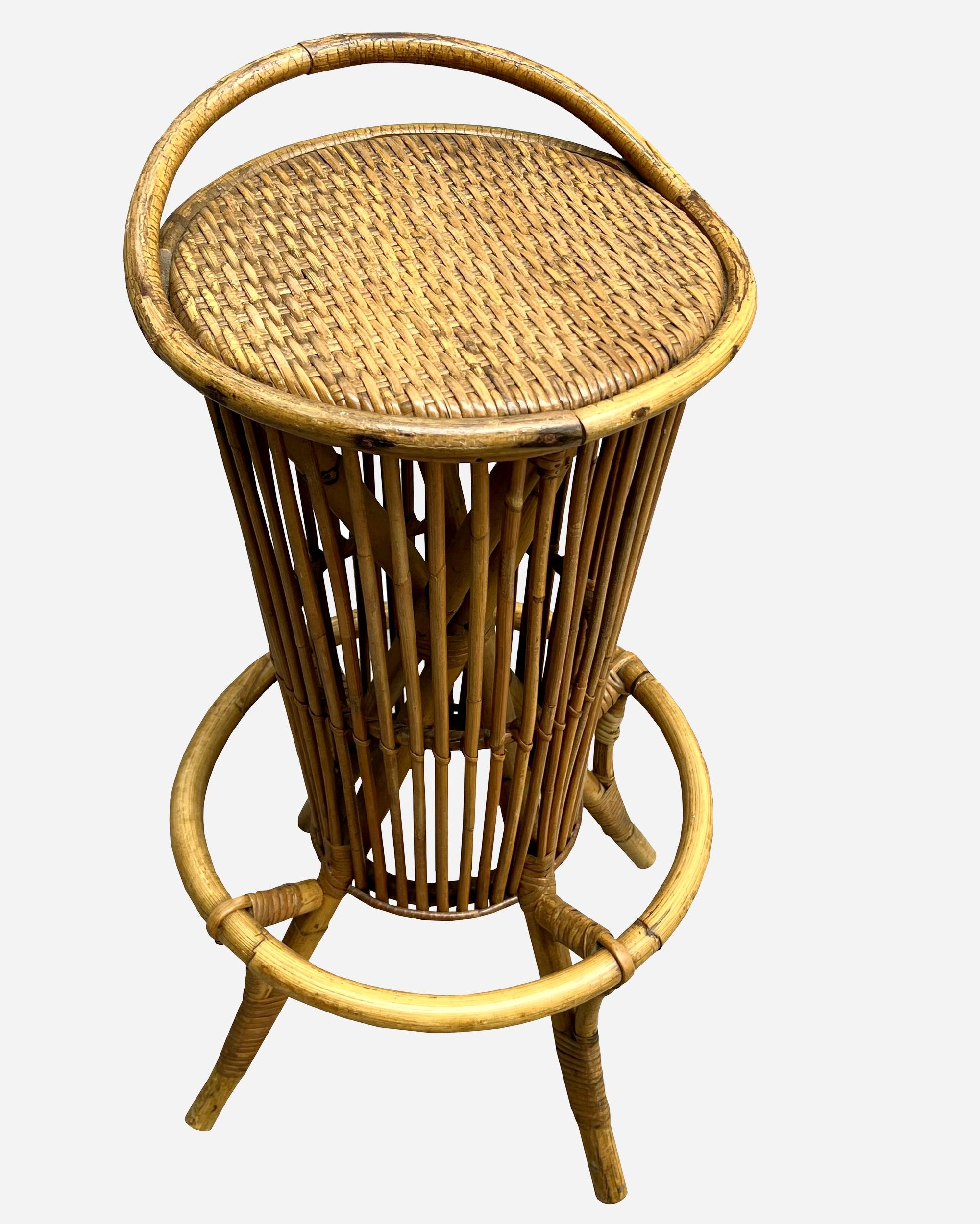 Set of four bamboo and rattan barstools in the spirit of Tito Agnoli, Italy circa 1960.
The seat is in woven rattan, the base is in bamboo and supports a circular footrest.
Seat diameter: 35 cm (13.8 inches)
Height: 83 cm (32.7 inches)
Seat height: