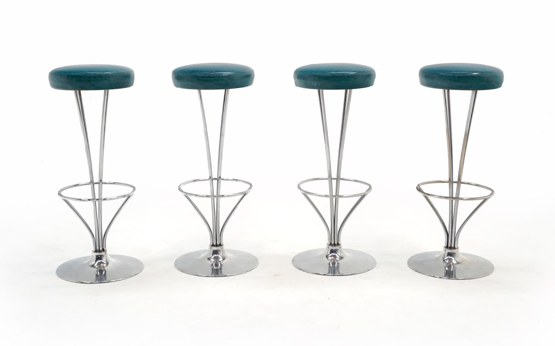 Set of 4 bar stools designed by Piet Hein for Fritz Hansen, Denmark, 1960s. The seats have been reupholstered in the recent past in high quality turquoise blue leather. The frames are made of cast aluminum and chromed steel. These are our favorite