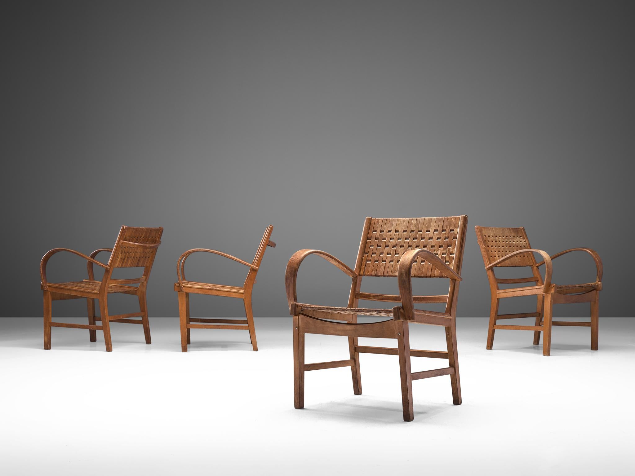 Erich Dieckmann for Gelenka, set of 4 armchairs, bent plywood, webbing, Germany, 1930s.

This German set is executed with bent plywood and solid wooden seat with a webbed back. The style is typical for prewar German design. Playful, bold curves and