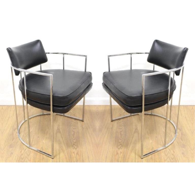 Four Milo Baughman dining chairs for Thayer Coggin. Newly upholstered in black features unique ellipse chrome frames with thick padded seating and a tufted floating backrest.