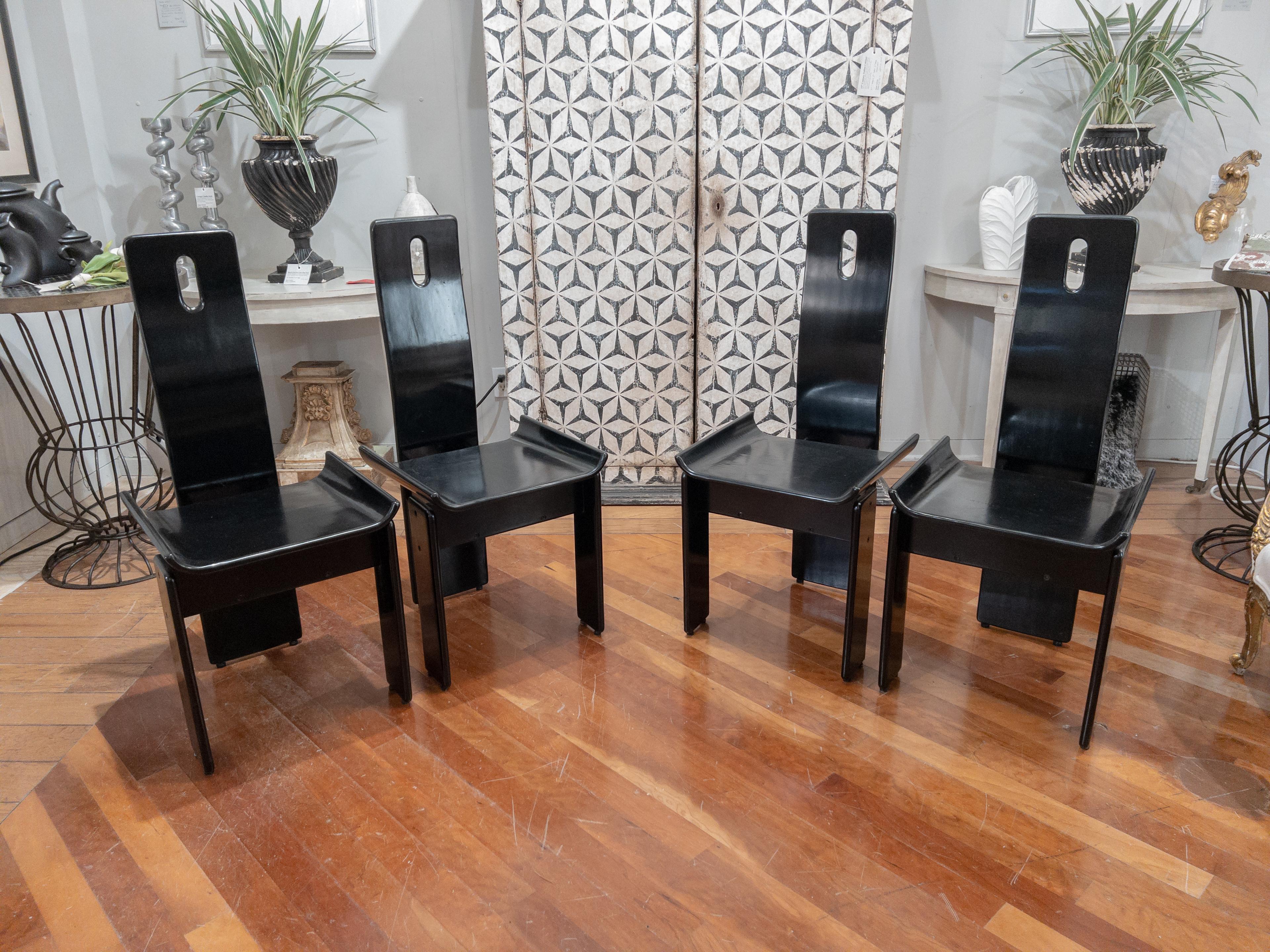 High- back dining chairs attributed to the noted Italian designer Pietro Costantini in black lacquered wood. From a Manhattan Estate.