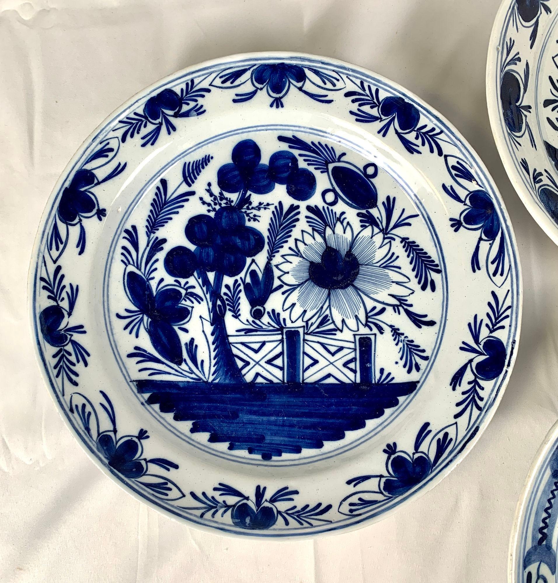 Made in The Netherlands circa 1800, this set of four similar blue and white chargers shows a traditional garden scene.
In the center, the chargers show a single large flower, blue rockwork, and a profusion of leaves on a white ground.
Each of the