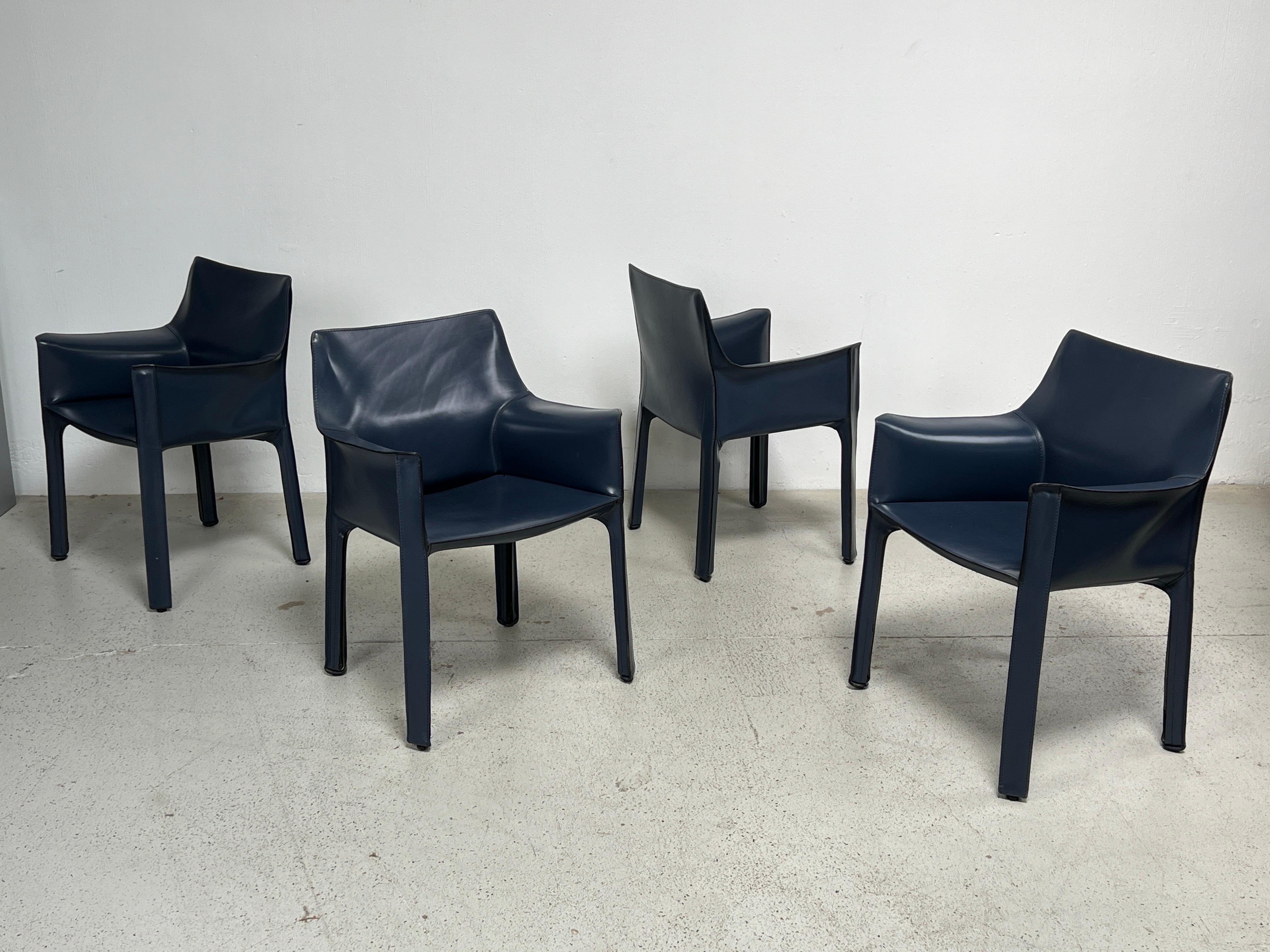 A set of four blue leather Cab arm chairs designed by Mario Bellini for Cassina. 