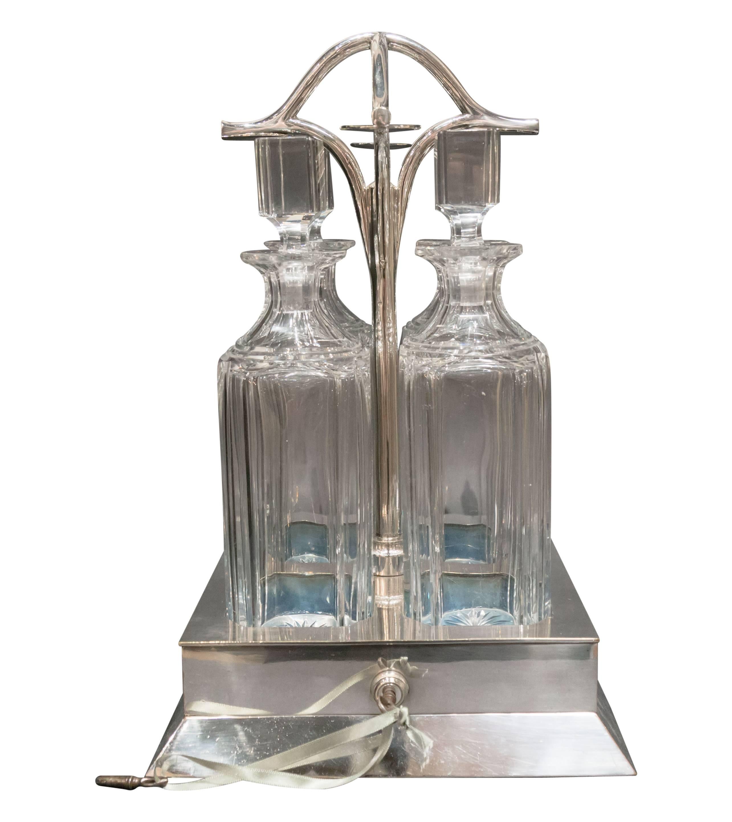 British Four Bottle Locking Tanalus with Silver Plate, circa 1890