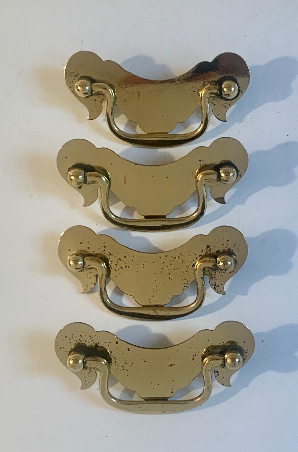 A set of four vintage brass door pulls in the style of Chippendale - the four are from an original piece of furniture we no longer could save. Wonderfully patinated and ready for installation with screws in opposing side.

Depth of material should