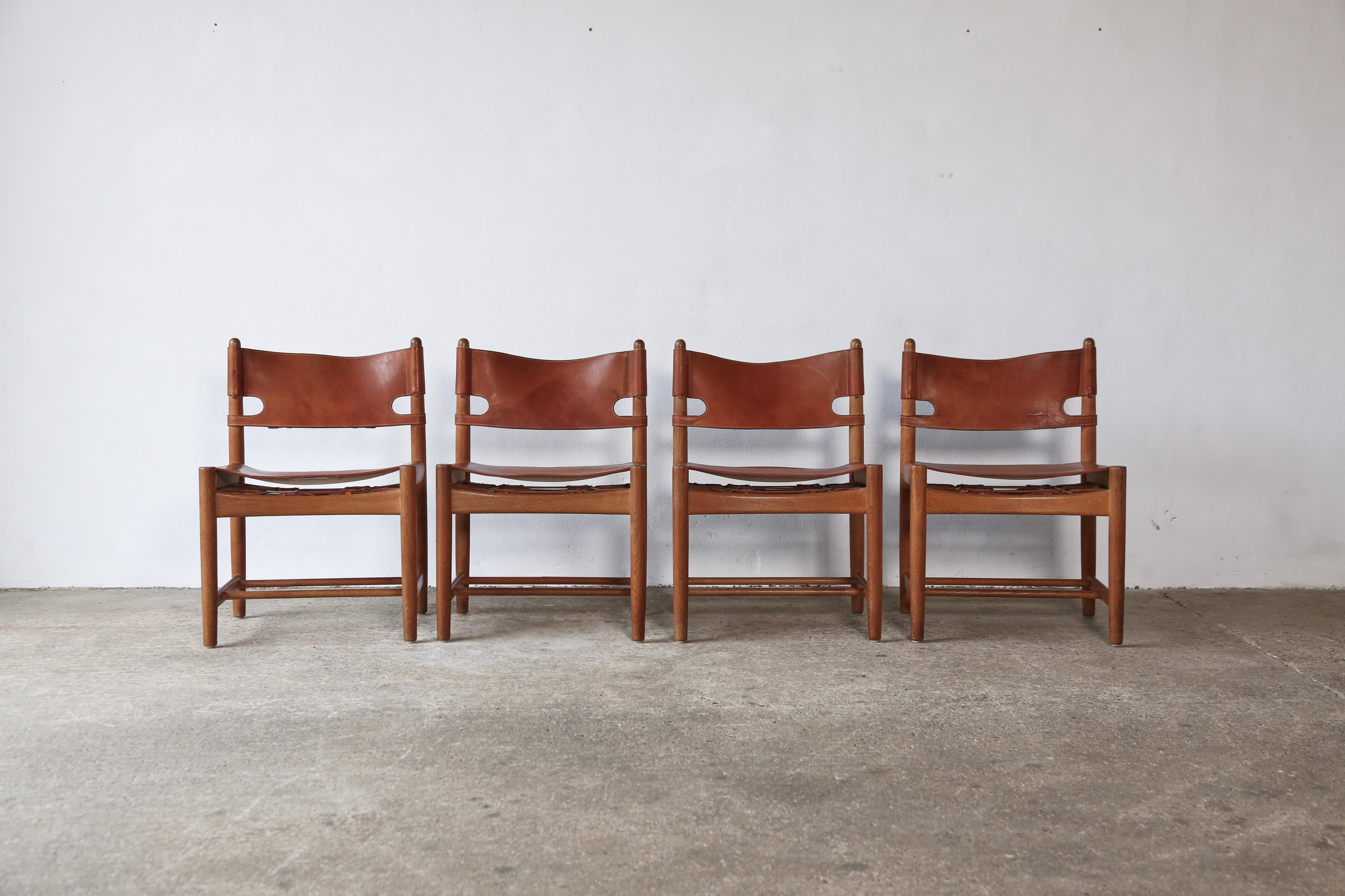A set of four Børge Mogensen dining chairs model no. 3251 for Fredericia Furniture, with saddle leather on an oak frame, in original condition with a wonderful age and patina.  Fast shipping worldwide.   Please contact us for a competitive shipping
