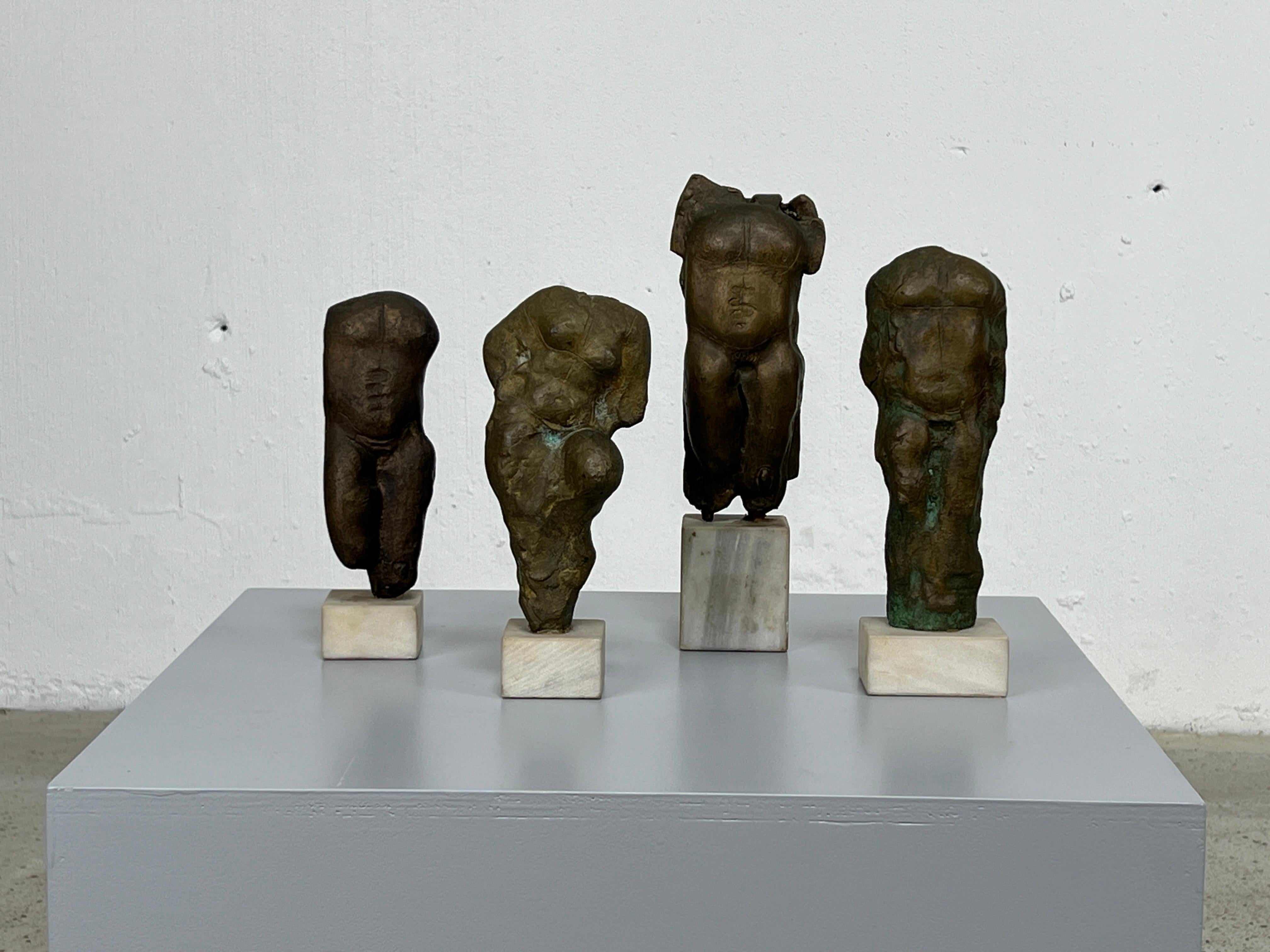 A group of four bronze torso sculptures on marble bases. Signed by artist. Largest stands at 10.25
