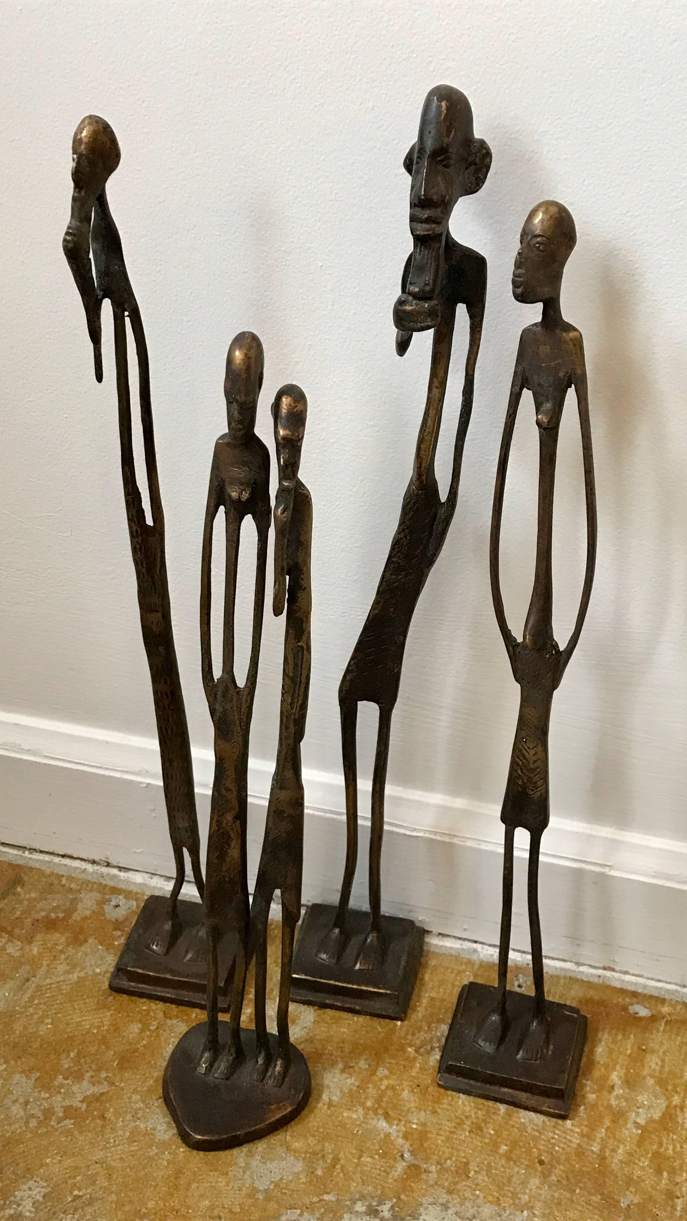 Very cool grouping of four abstract figural sculptures in the style of Giocometti, cast in bronze.