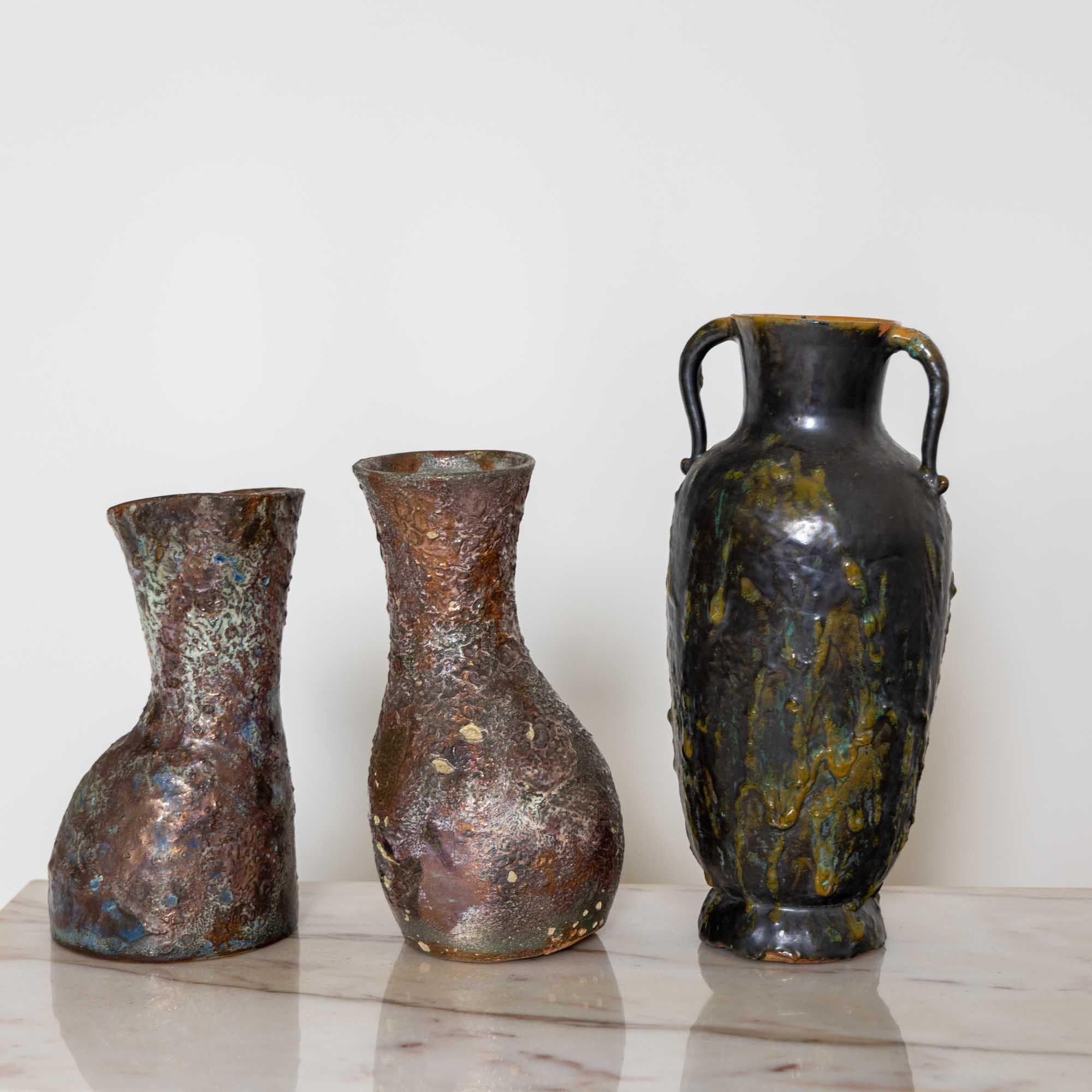 Four unique ceramic vases with rough surfaces in dark dramatic colours by Nereo Boaretto (1914-1977). 

Signed Nereo Boaretto on the bottom and partially dated.