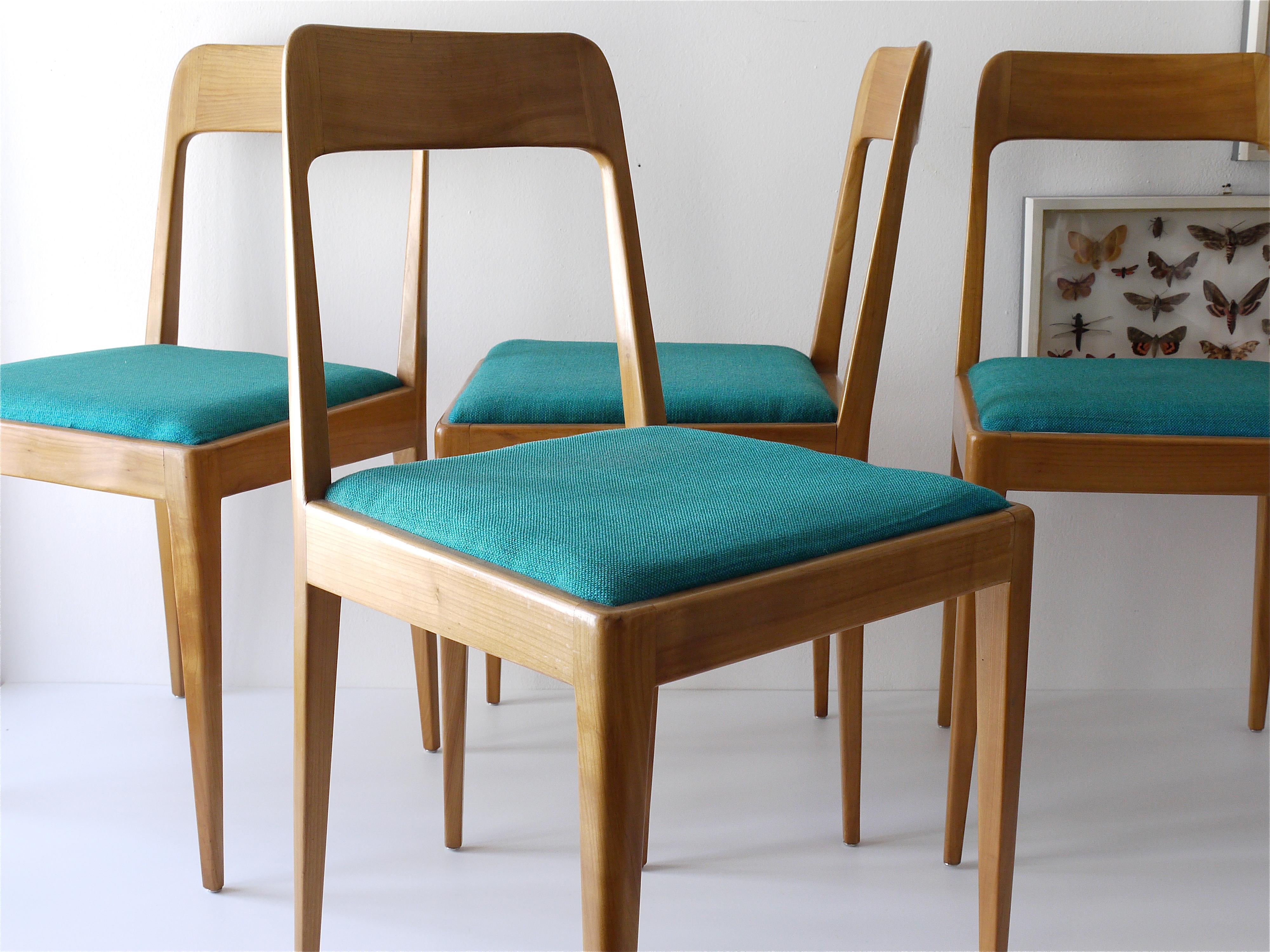 A matching set of four comfortable and elegant Austrian modernist dining room or side chairs. Model no. A7, designed and executed by Carl Aubock and Robert Nestler in the 1950s. Straight organic design, made of walnut with an upholstery of green