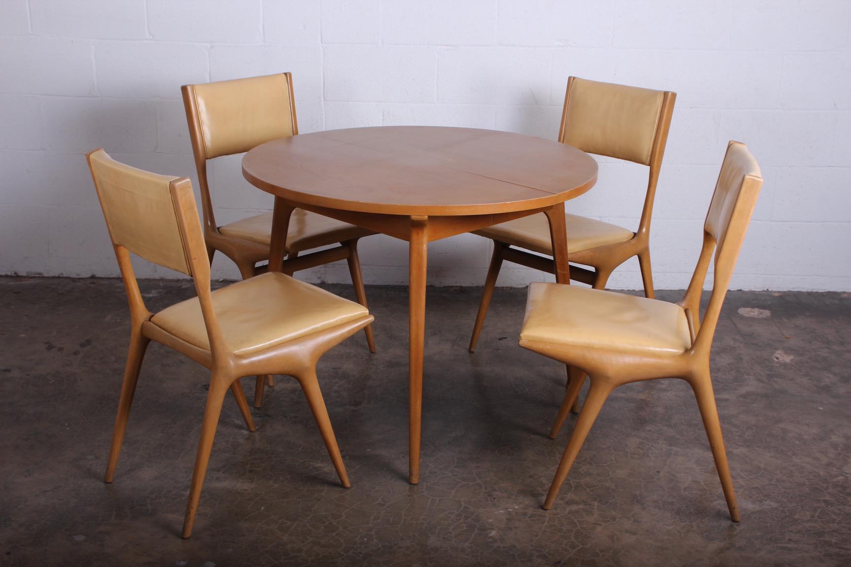 A set of four chairs by Carlo de Carli for Singer and Sons in original bleached finish with original leather.