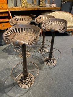 Four Cast Iron Bar Stools Made of 19th Century Buckeye Akron Tractor Seats