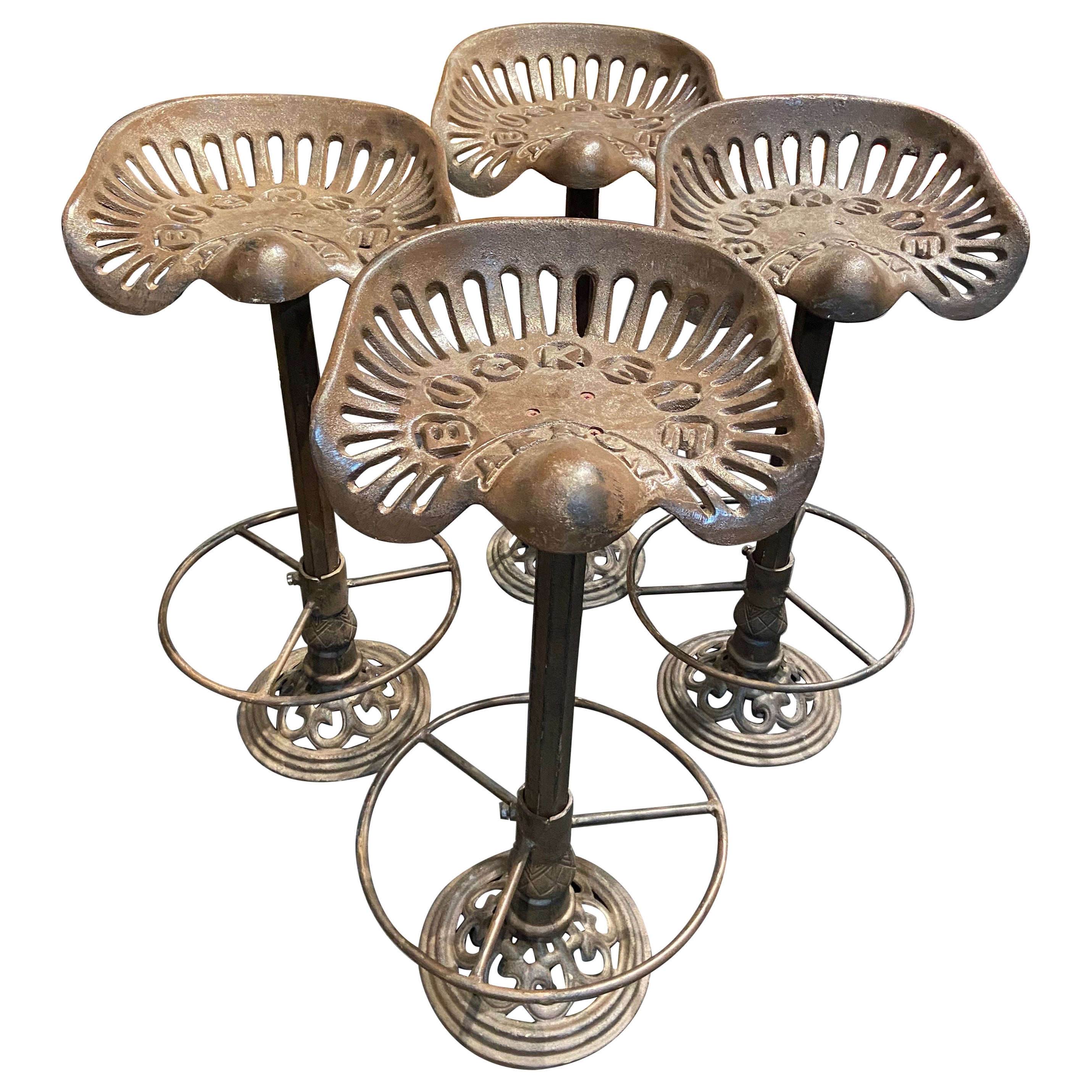 Four Cast Iron Bar Stools Made of 19th Century Buckeye Akron Tractor Seats