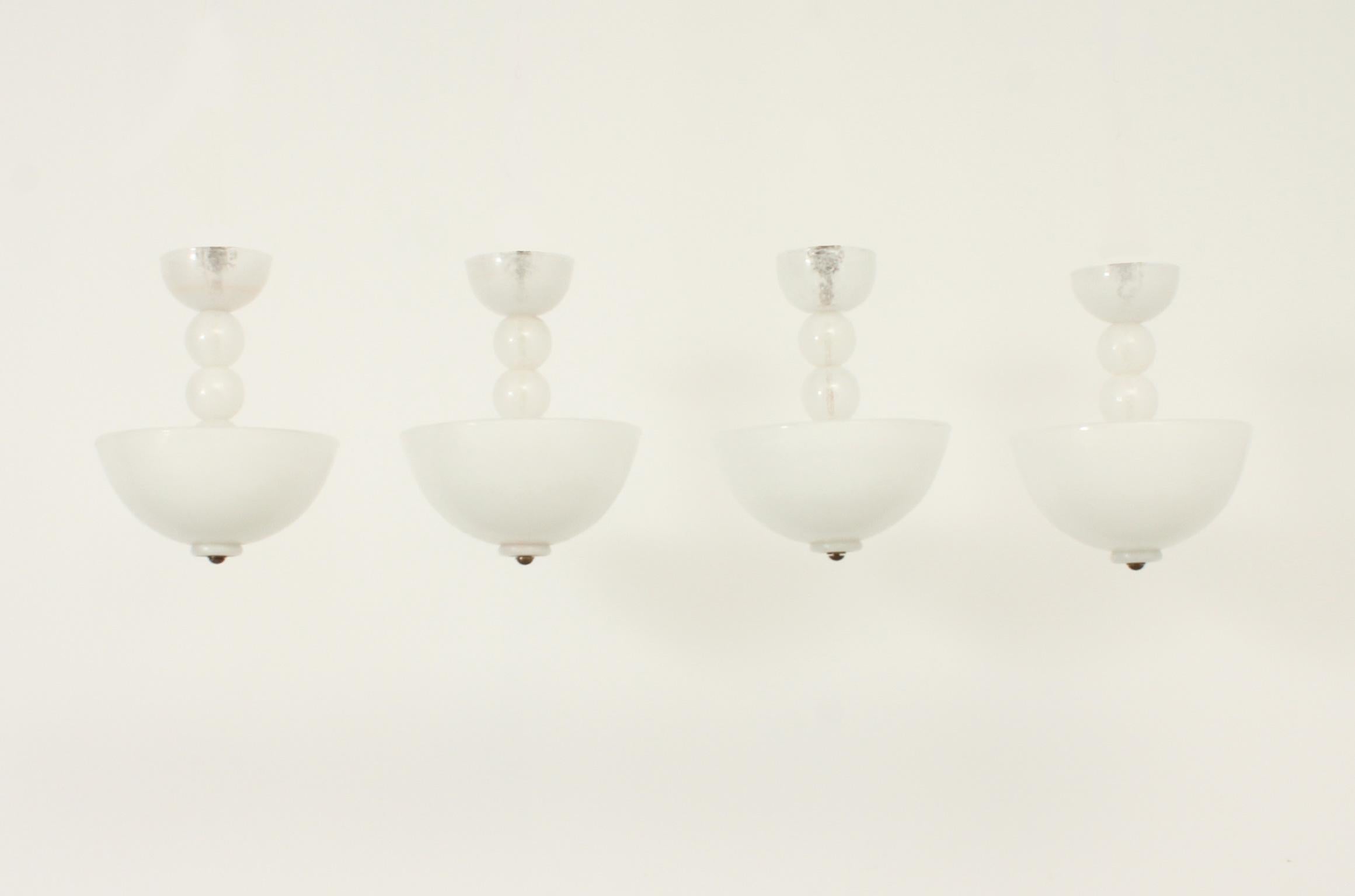 Four ceiling lamps by Barovier & Toso, Italy, 1950's. Hand blown pulegoso glass and brass. Three bulbs in each lamp with new wire adapted to european and US use.