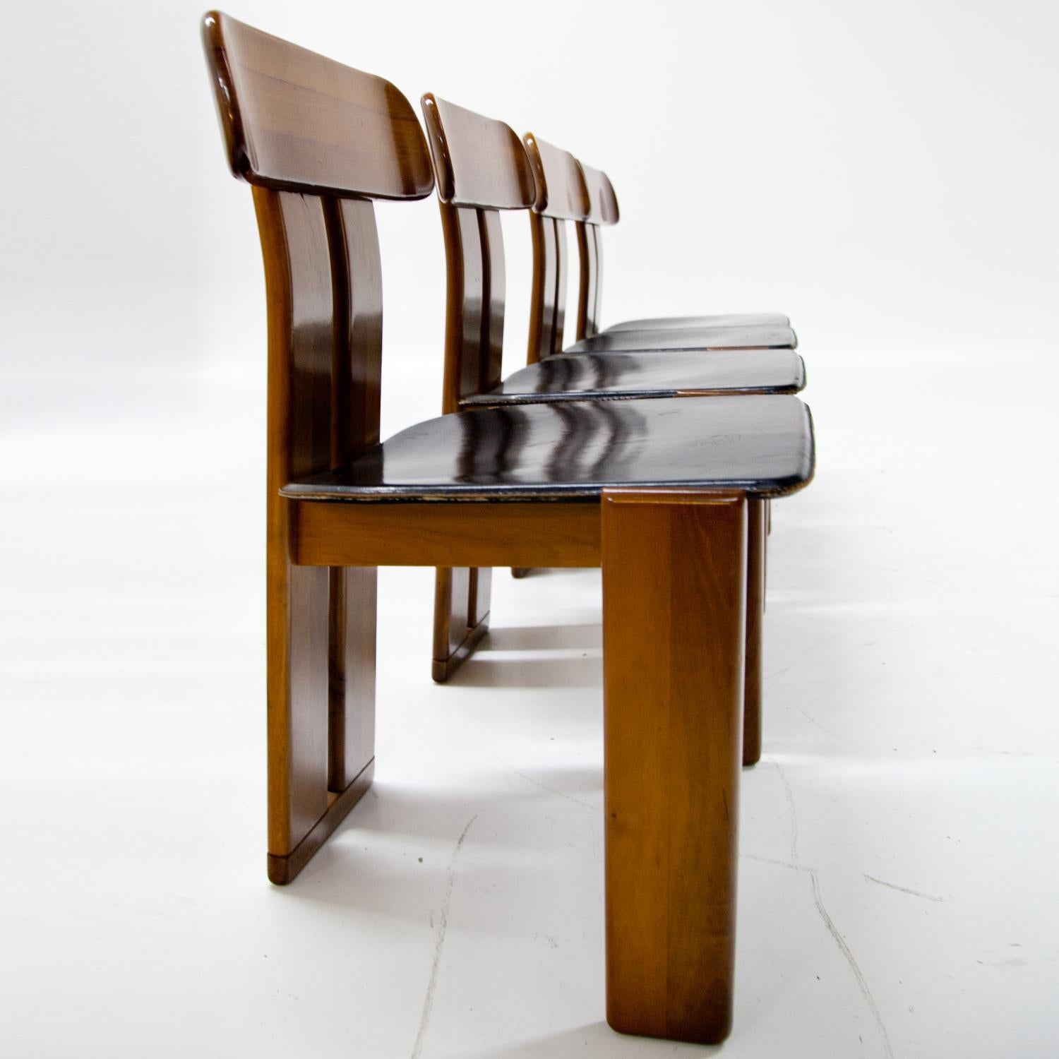 Four dining room chairs with black leather seats attributed to Afra & Tobia Scarpa for Maxalto.