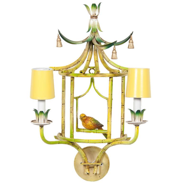 Very unusual chinoiserie wall sconces with hanging birds date from the mid-20th century, each having top with stylized leaves and frame painted to look like bamboo, including a hanging perch with bird in center, and two lights on front. Electrified.