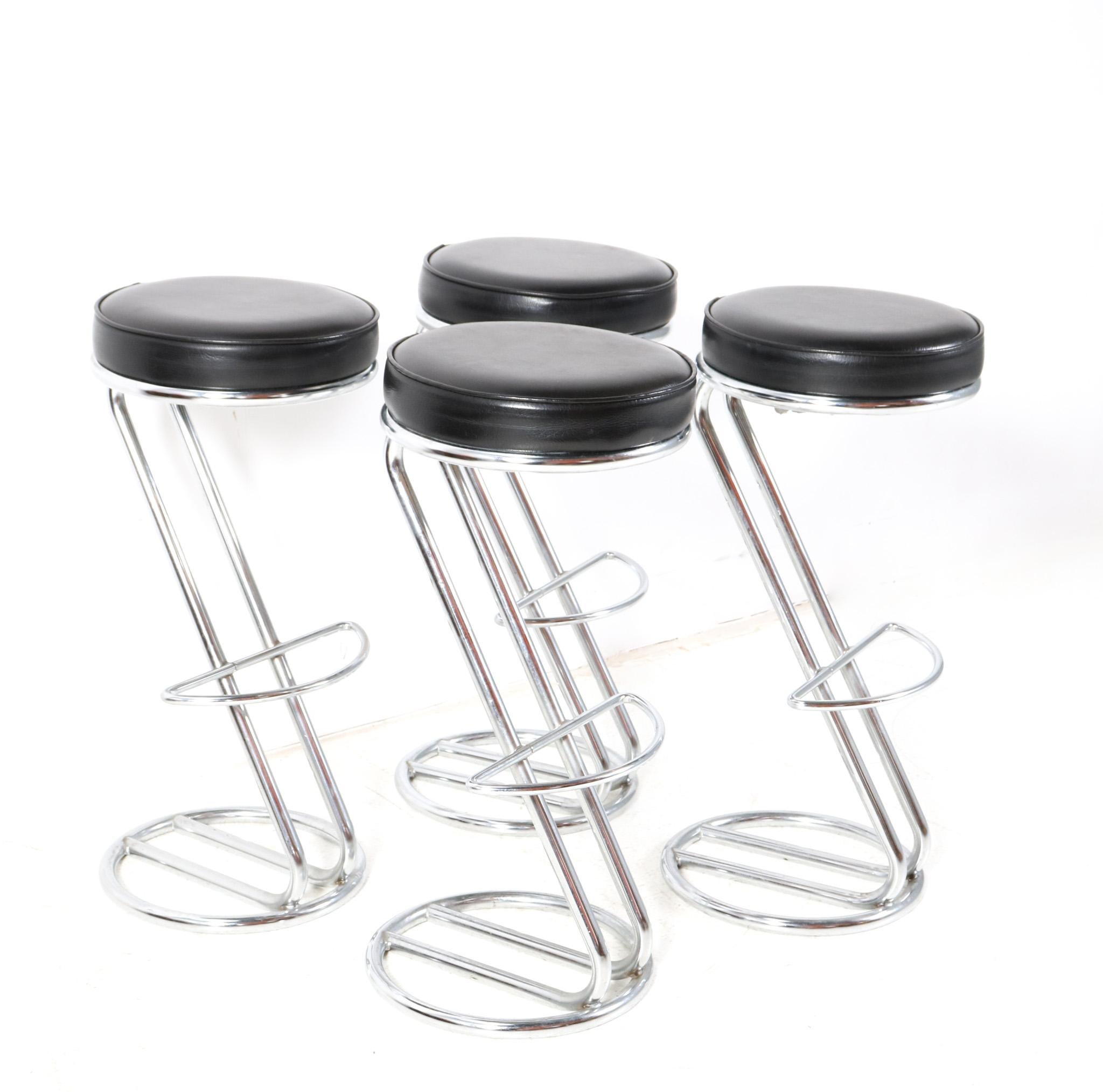 Stunning and elegant set of four Mid-Century Modern barstools.
Striking Dutch design from the 1970s.
Original chrome-plated metal base with original black faux leather seat.
This wonderful set of four Mid-Century Modern barstools is in very good