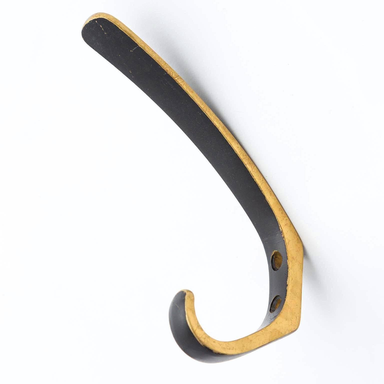 One of four beautiful Austrian brass hooks by Hertha Baller, Austria, manufactured in midcentury (late 1950s or early 1960s). 
They are made of blackened and partly polished brass with lovely patina.